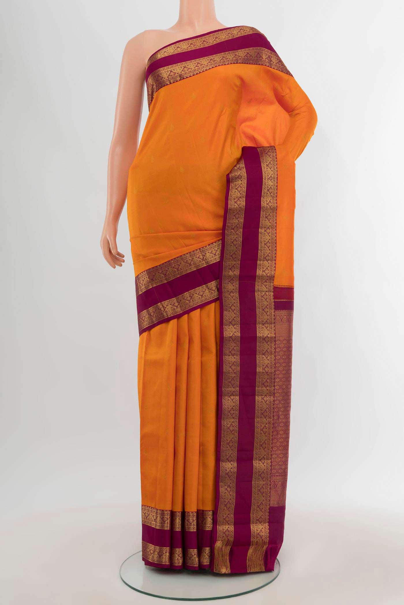 Orange Kanchipuram Silk Saree with Zari Butta on the body and Zari Border.  displayed on a mannequin