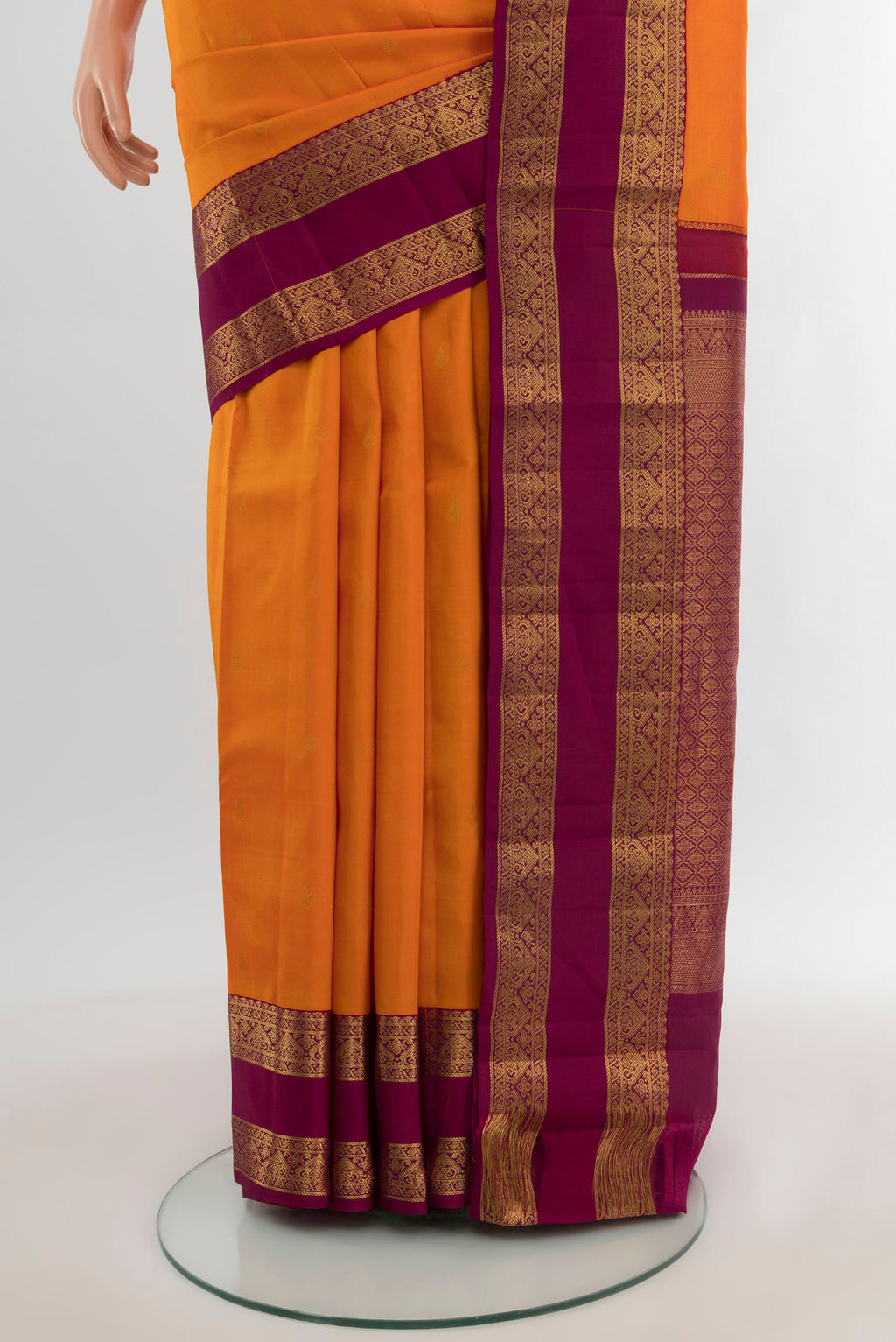 Pleats and pallu of Orange Kanchipuram Silk Saree with Zari Butta on the body and Zari Border. 