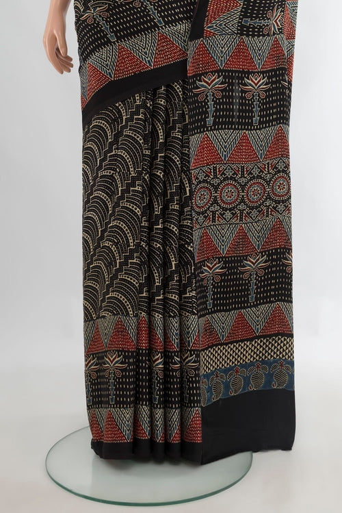 Pleats and pallu of Black Satin Crepe Saree with Floral Print on the body and Printed Border. 
