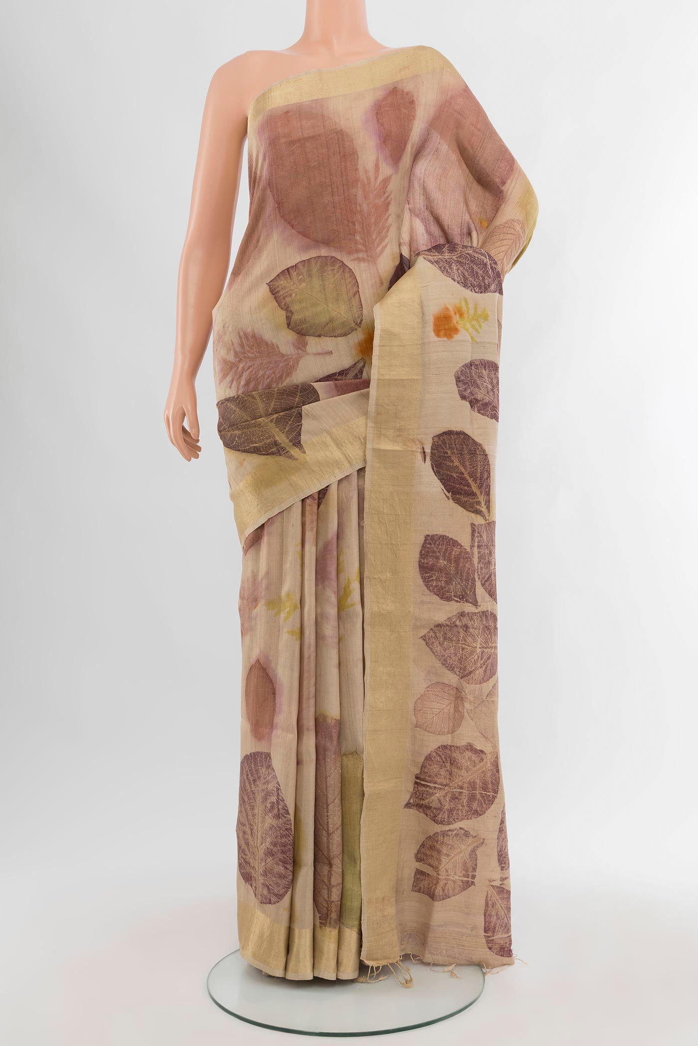 Beige Tussar Silk Saree with Floral Print on the body and Zari Border.  displayed on a mannequin