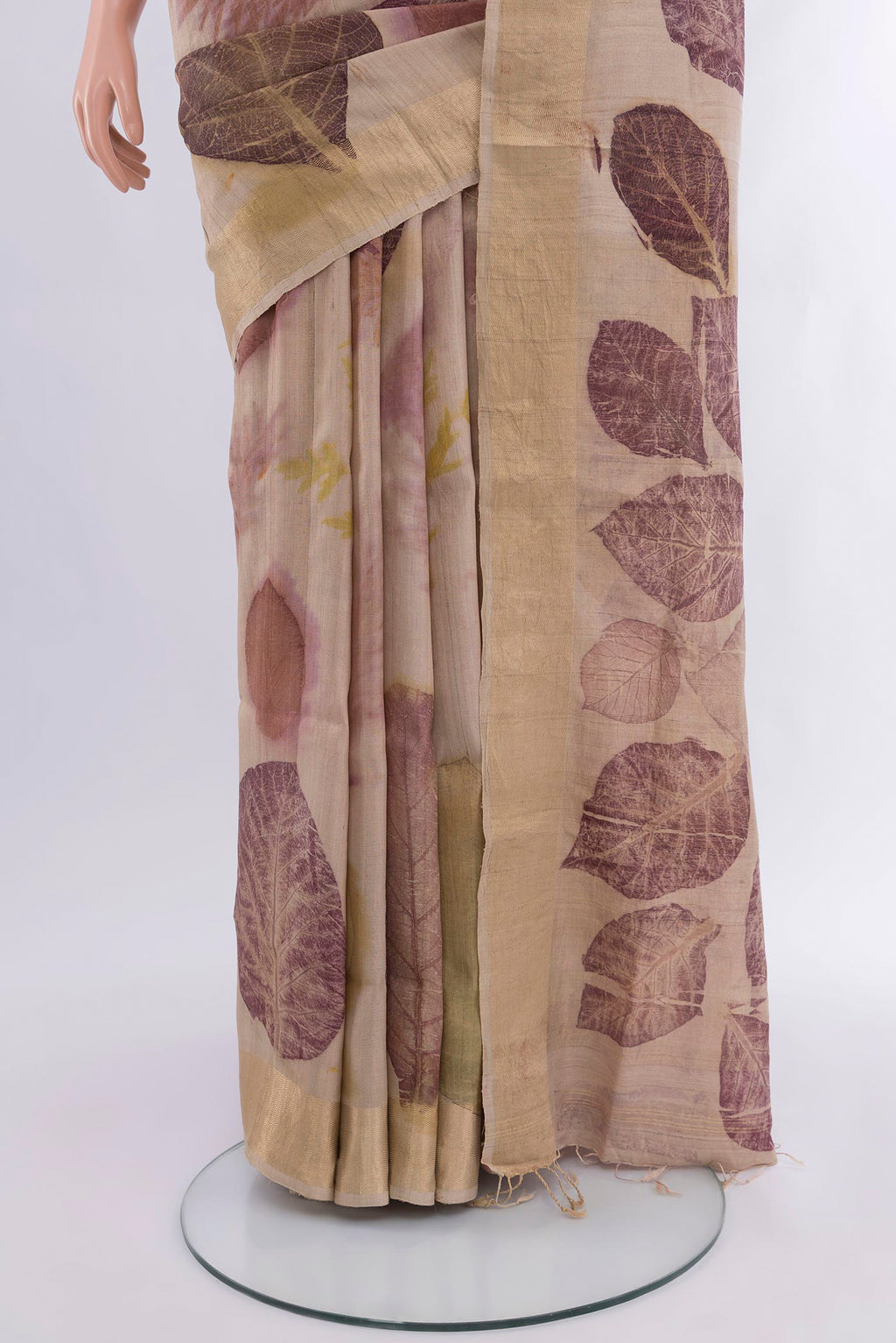 Pleats and pallu of Beige Tussar Silk Saree with Floral Print on the body and Zari Border. 
