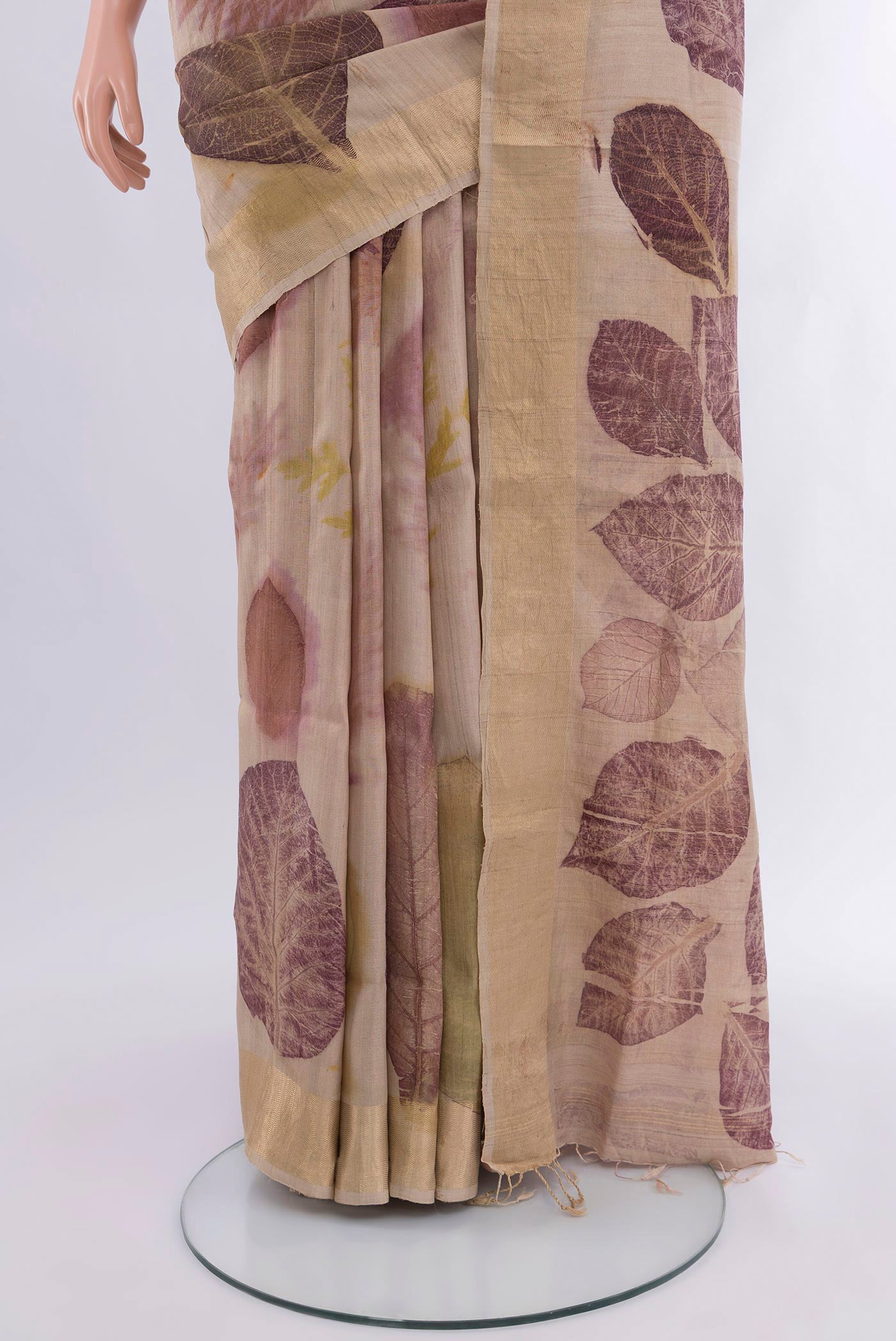 Pleats and pallu of Beige Tussar Silk Saree with Floral Print on the body and Zari Border. 