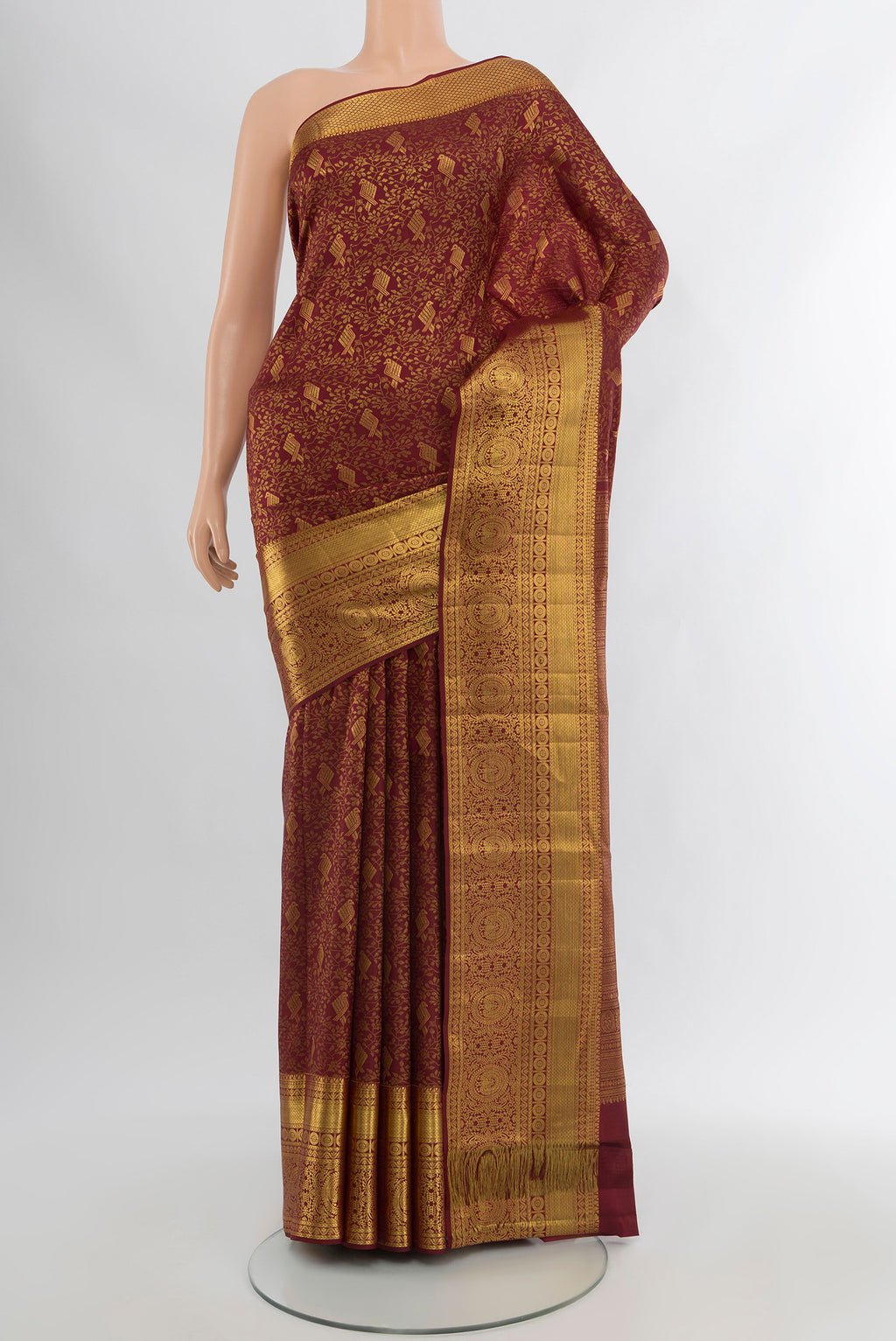 Pure Silk Pure Zari Maroon Kanchipuram Saree with Zari Butta on the body and Silk Border.  displayed on a mannequin