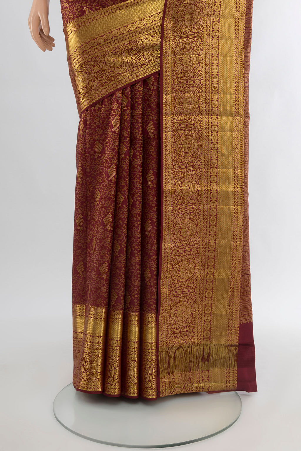 Pleats and pallu of Pure Silk Pure Zari Maroon Kanchipuram Saree with Zari Butta on the body and Silk Border. 