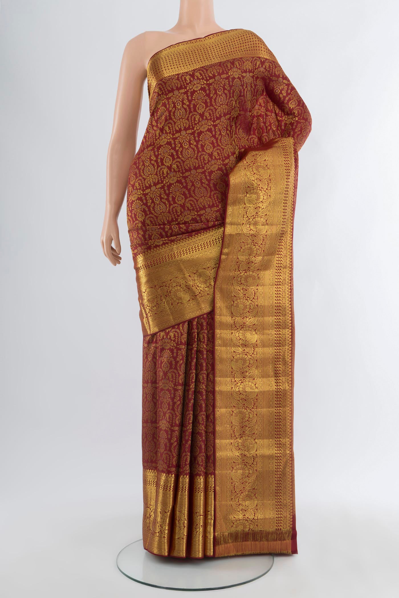 Maroon Kanjivaram Silk Saree with Zari Brocade on the body and Zari Border.  displayed on a mannequin