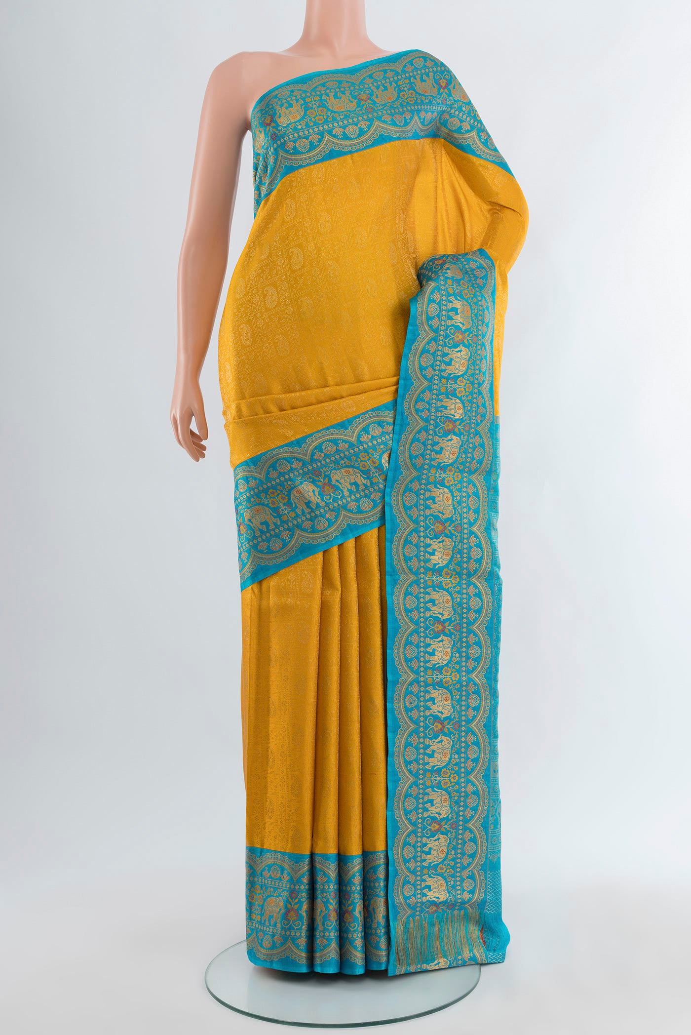 Yellow Kanjivaram Silk Saree with Zari Brocade on the body and Zari Border.  displayed on a mannequin