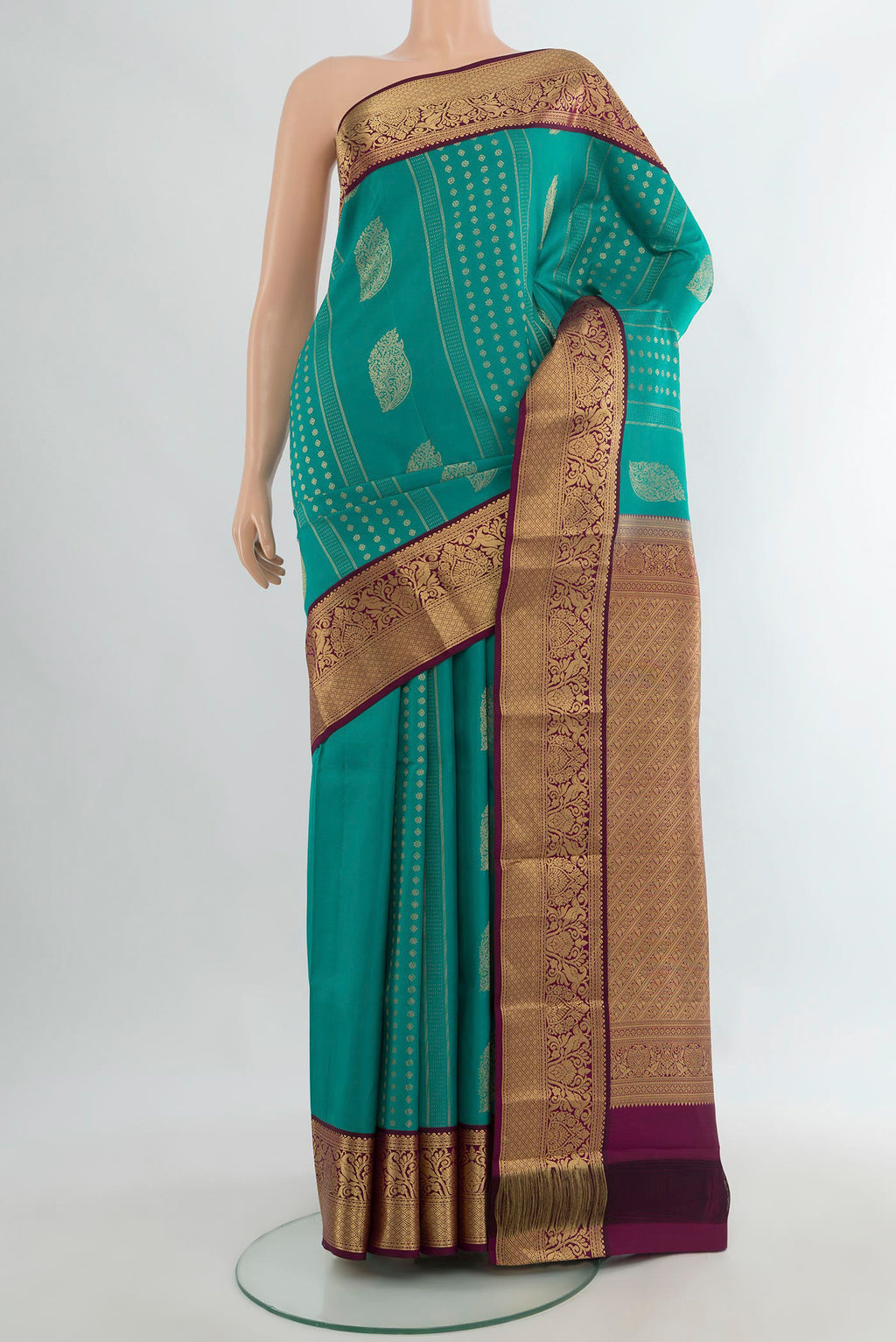 Pure Silk Turquoise Kanjivaram Saree with Zari Butta on the body and Zari Border.  displayed on a mannequin