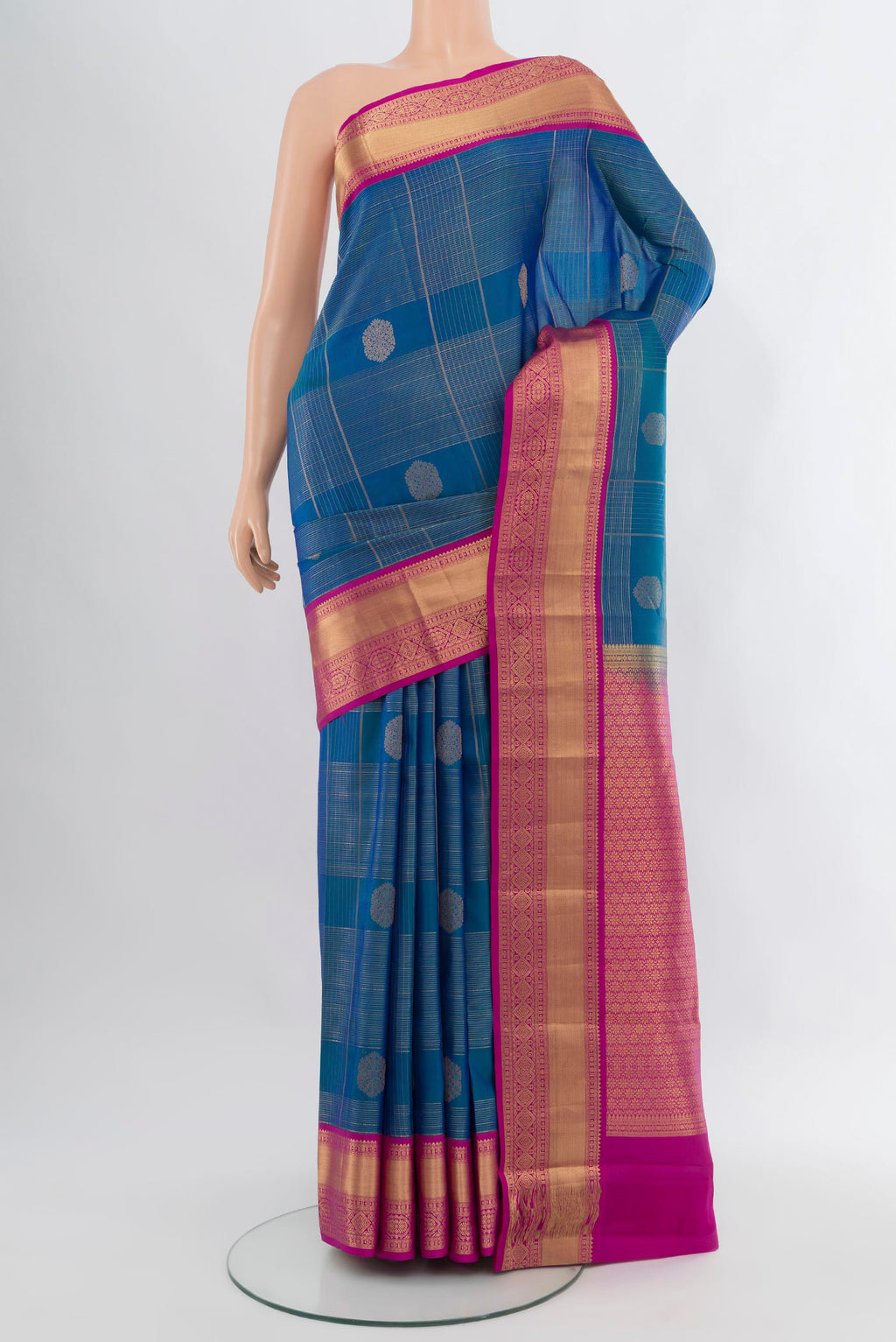Royal Blue Kanjivaram Silk Saree with Zari Butta on the body and Zari Border.  displayed on a mannequin
