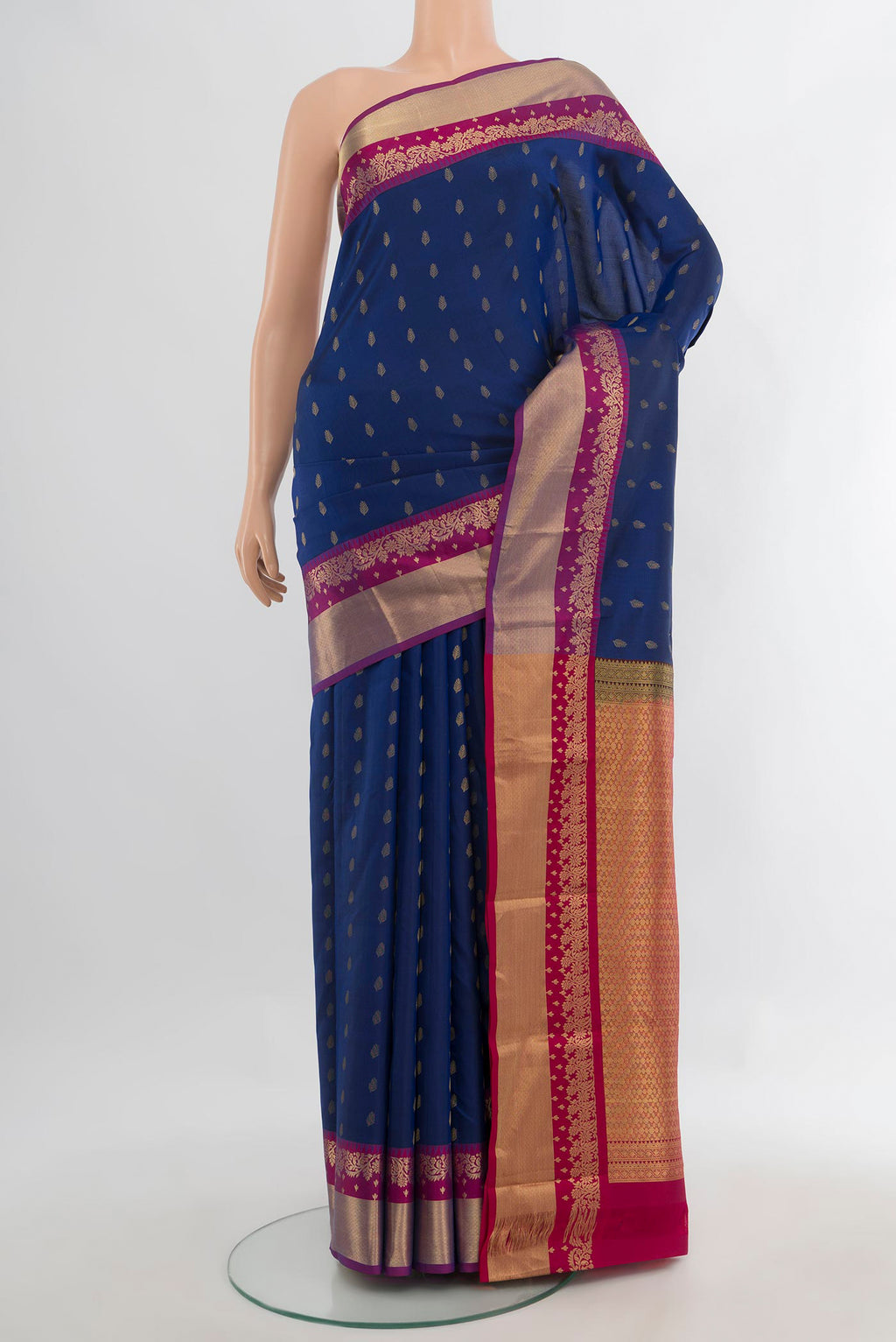 Pure Silk Blue Kanchipuram Saree with Zari Butta on the body and Zari Border.  displayed on a mannequin