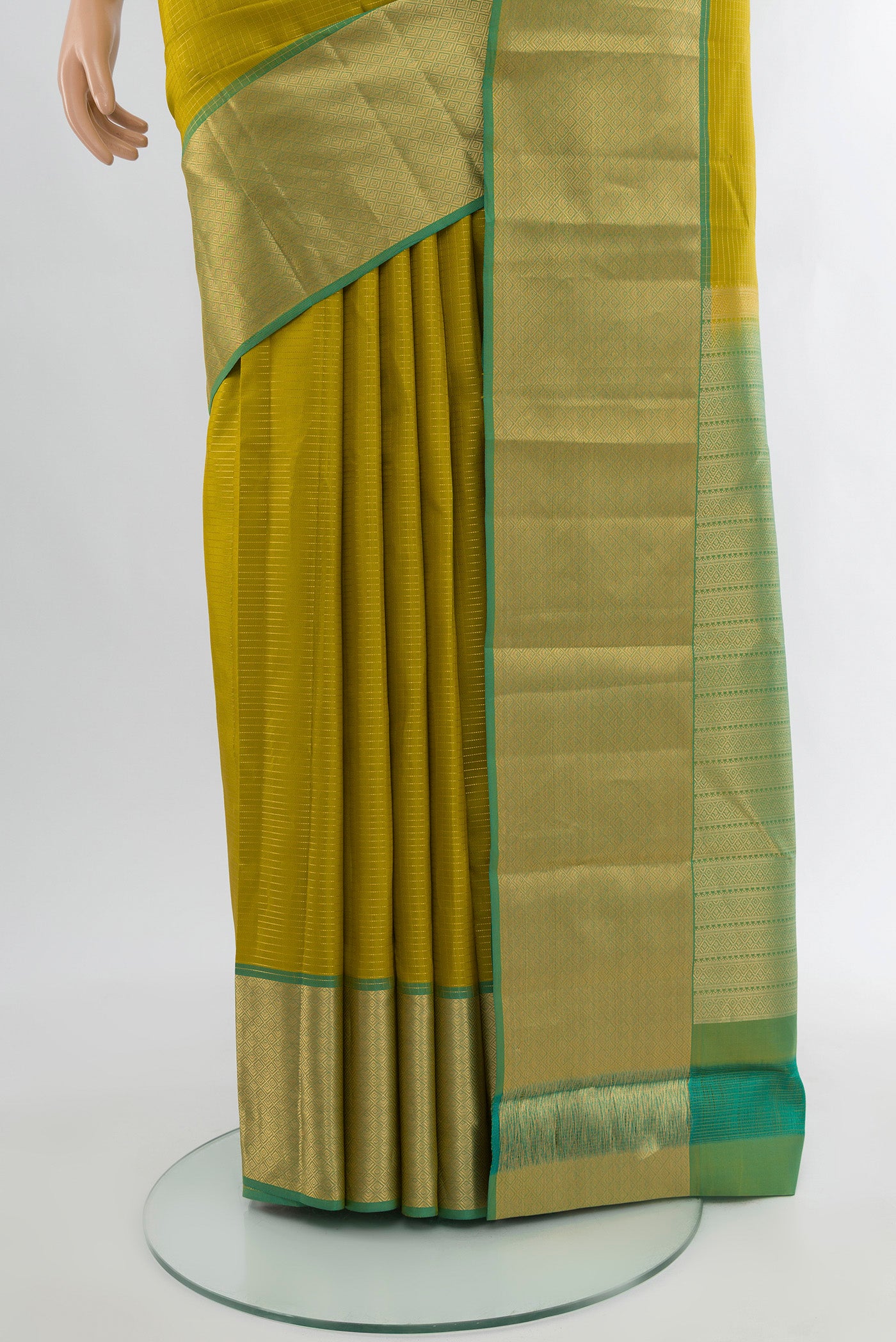 Pleats and pallu of Parrot Green Kanchipuram Silk Saree with Plain Body and Zari Border. 