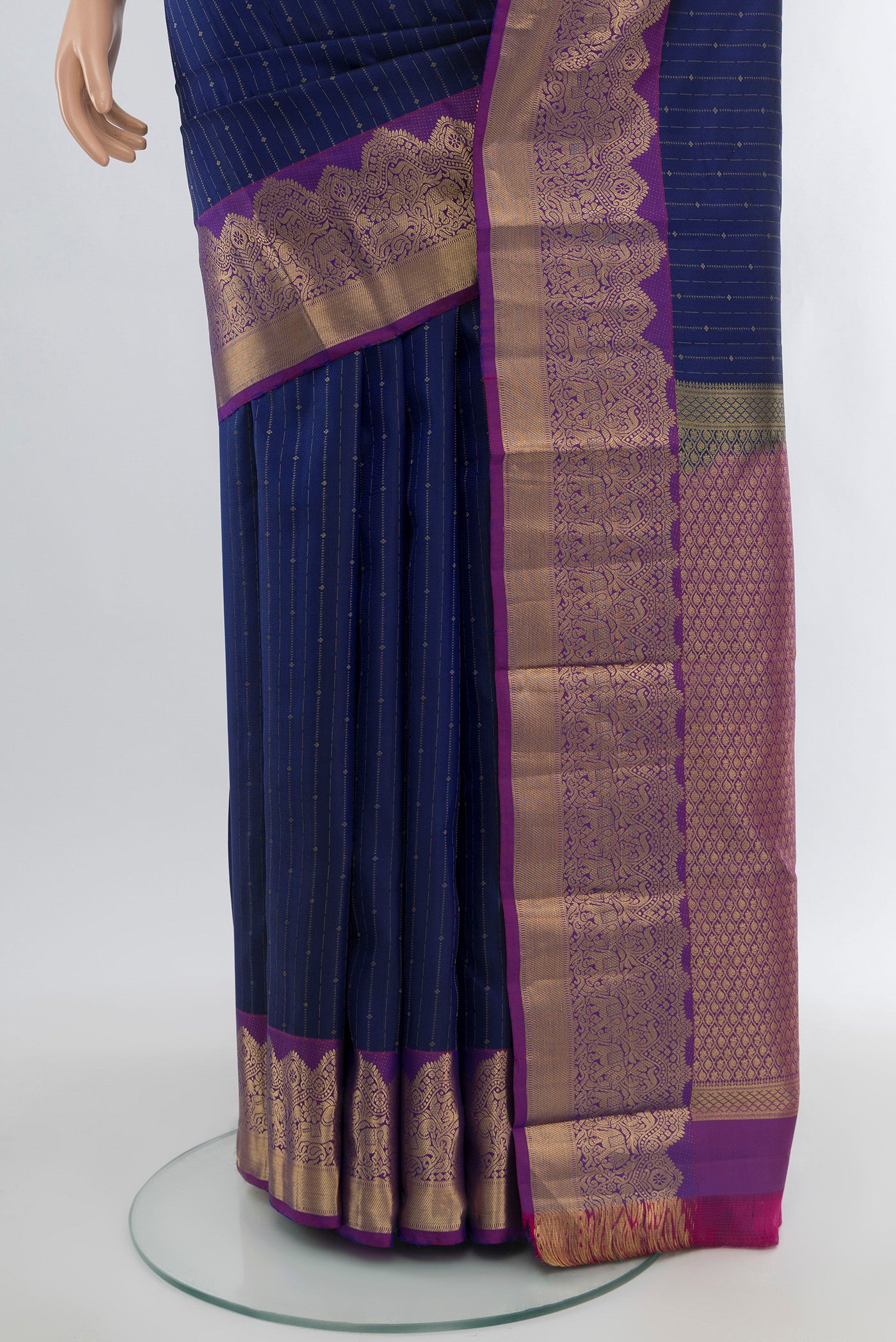 Pleats and pallu of Blue Kanchipuram Silk Saree with Stripes on the body and Zari Border. 