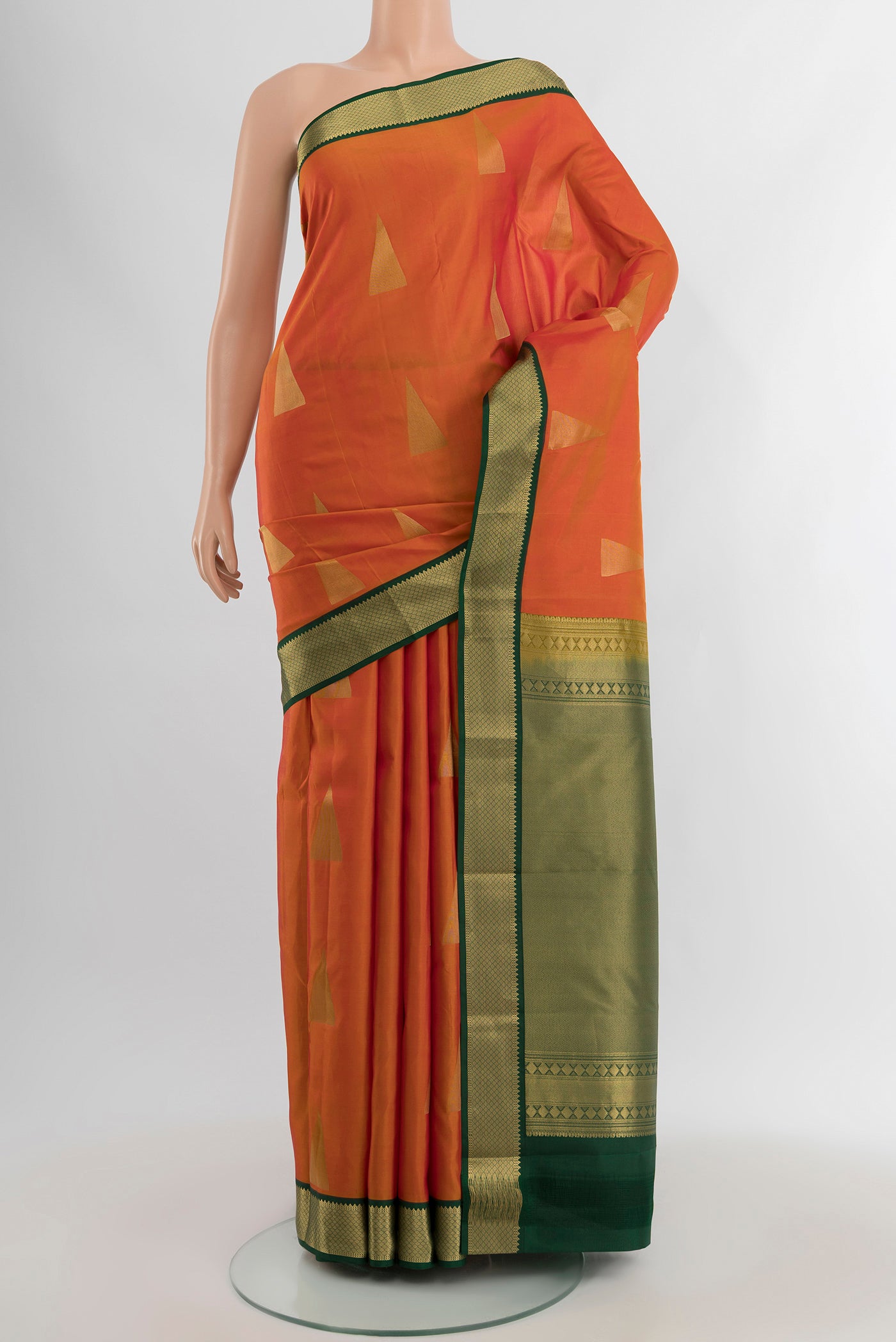 Orange Kanchipuram Silk Saree with Zari Butta on the body and Zari Border.  displayed on a mannequin