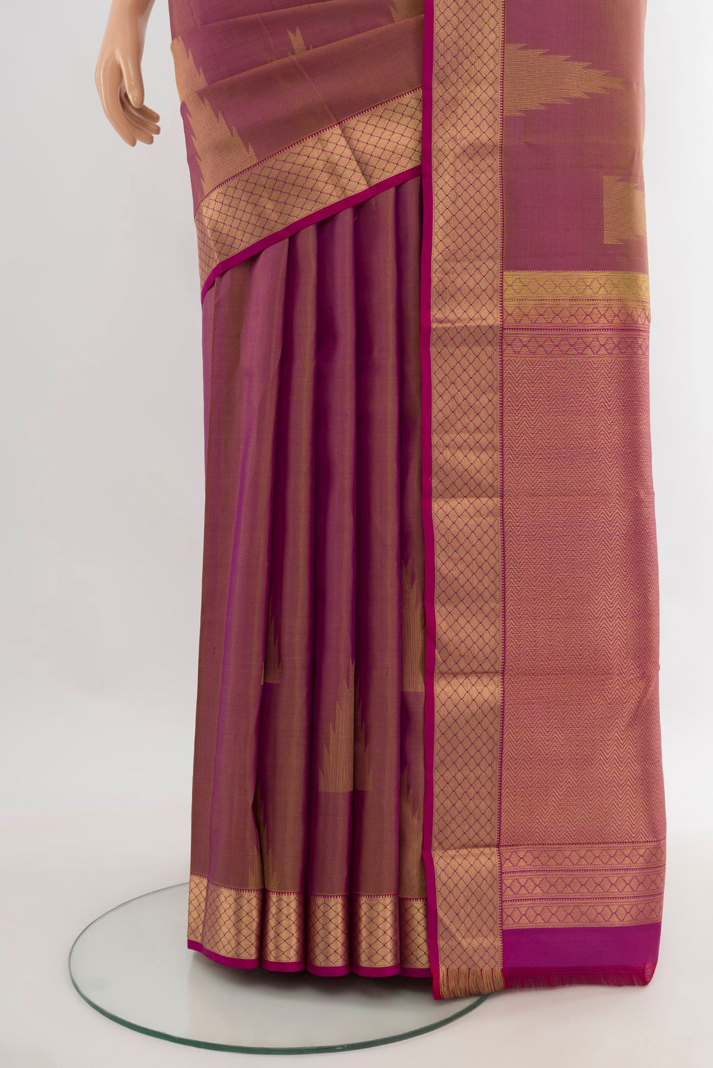 Pleats and pallu of Magenta Kanchipuram Silk Saree with Plain Body and Zari Border. 
