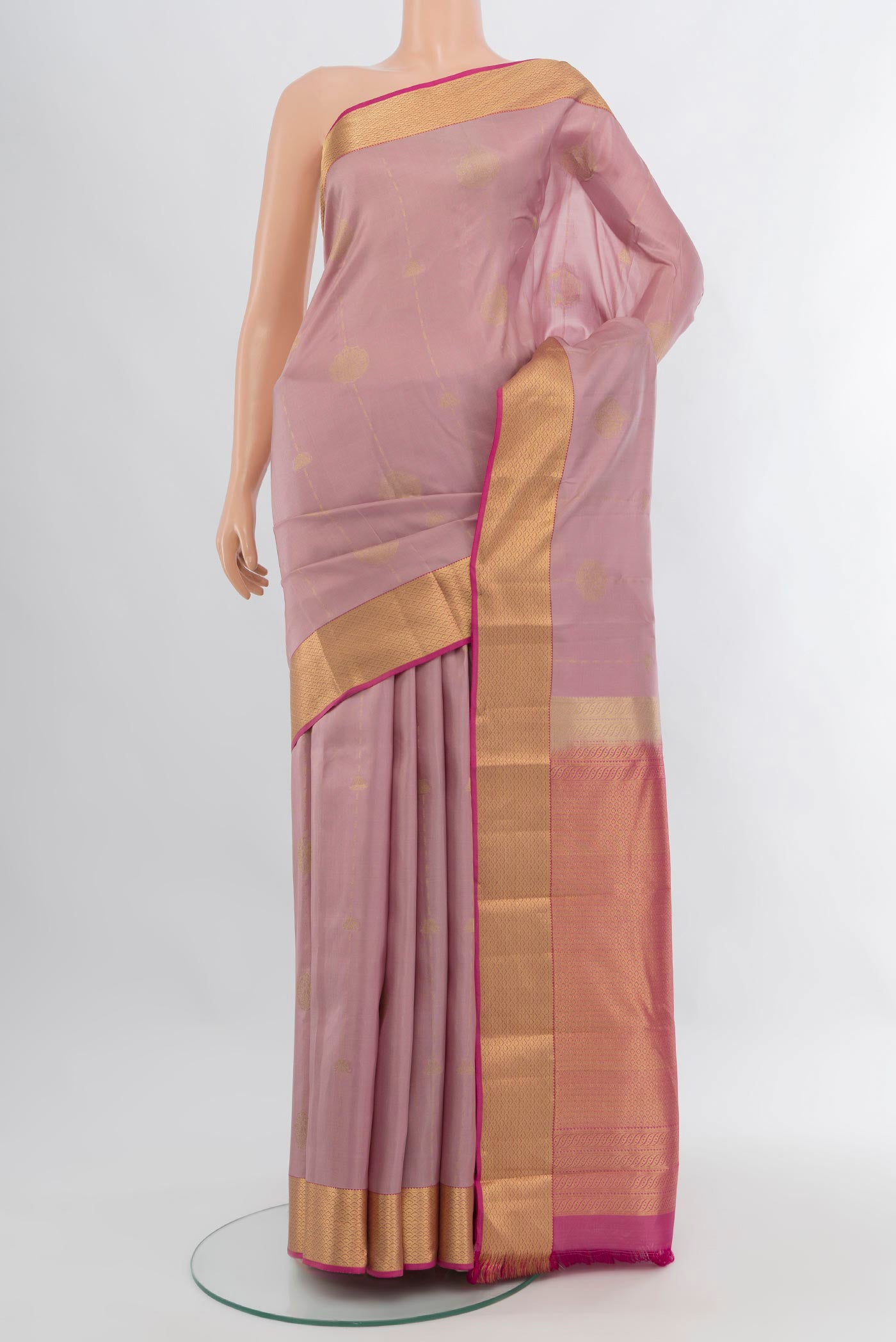Lavender Kanchipuram Silk Saree with Zari Butta on the body and Zari Border.  displayed on a mannequin