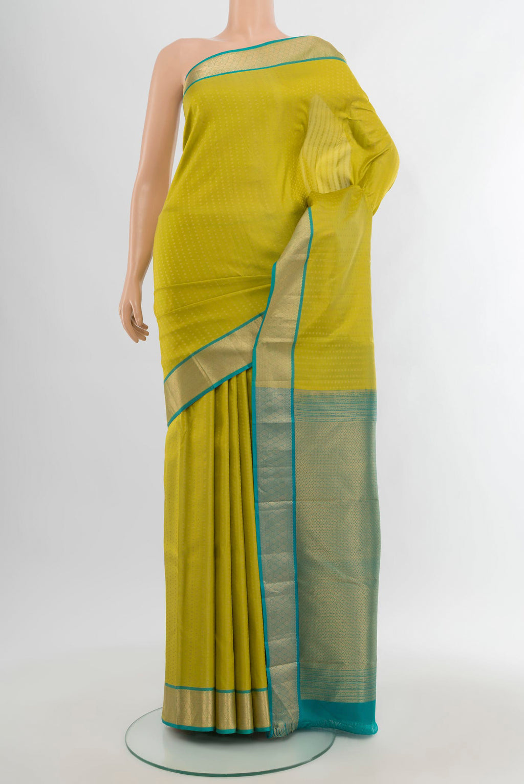 Parrot Green Kanchipuram Silk Saree with Zari Butta on the body and Zari Border.  displayed on a mannequin