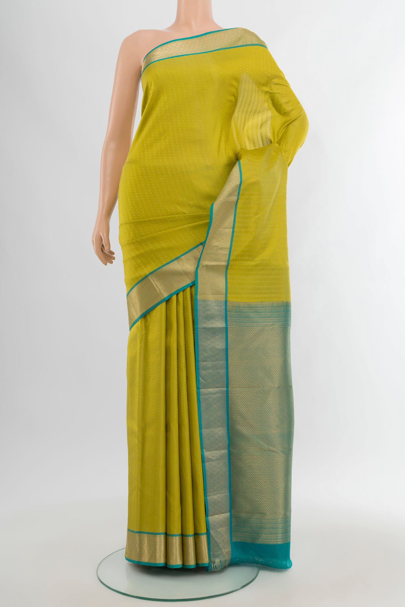Parrot Green Kanchipuram Silk Saree with Zari Butta on the body and Zari Border.  displayed on a mannequin