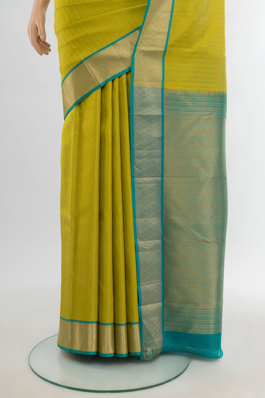 Pleats and pallu of Parrot Green Kanchipuram Silk Saree with Zari Butta on the body and Zari Border. 