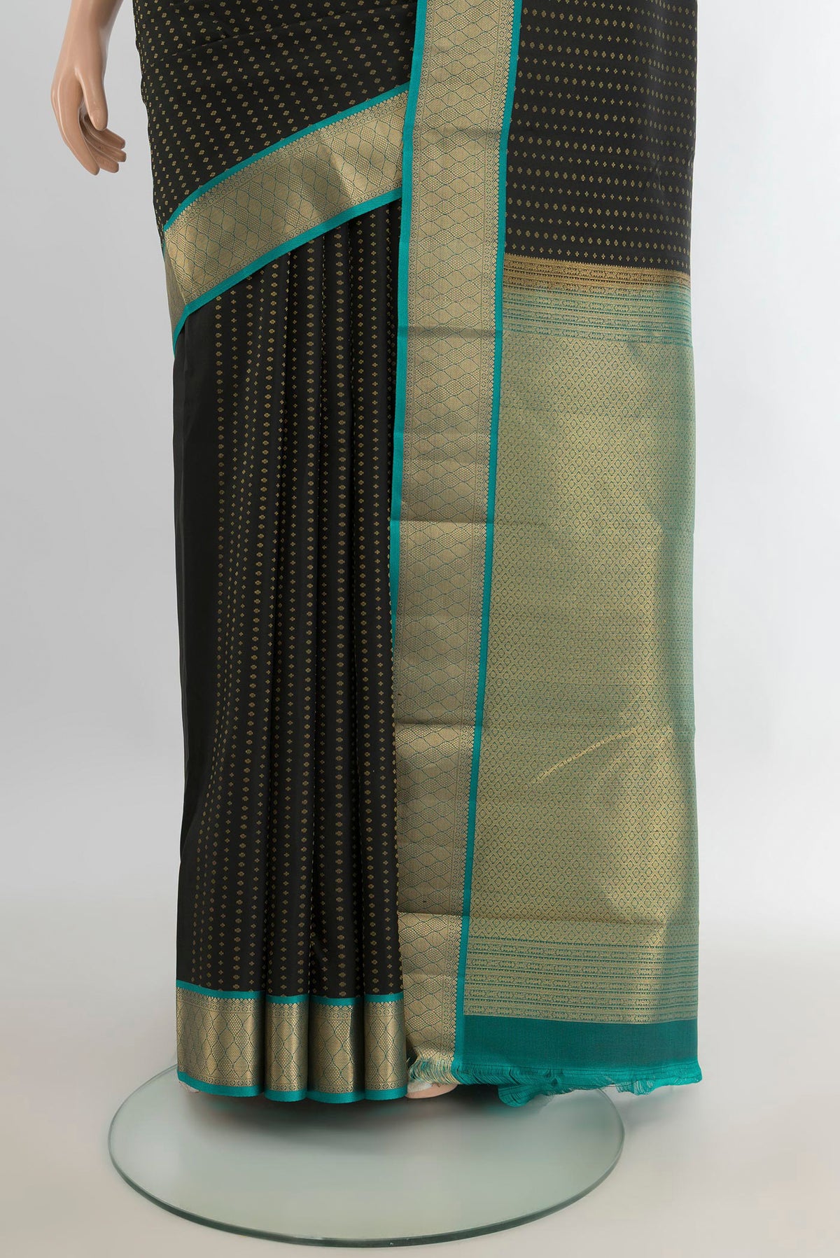 Pleats and pallu of Pure Silk Black Kanchipuram Saree with Zari Butta on the body and Zari Border. 