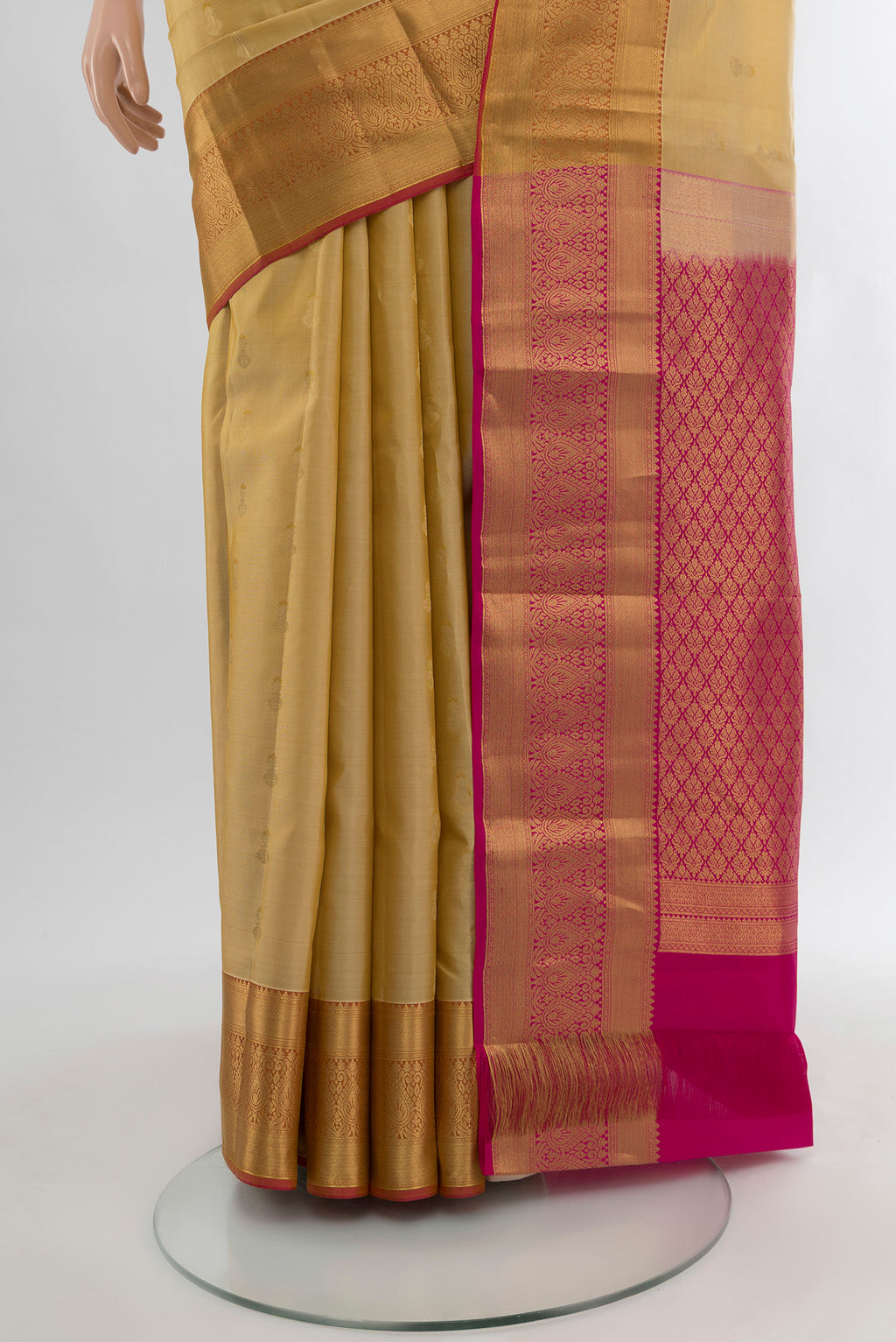 Pleats and pallu of Sandal Kanjivaram Silk Saree with Zari Butta on the body and Silk Border. 