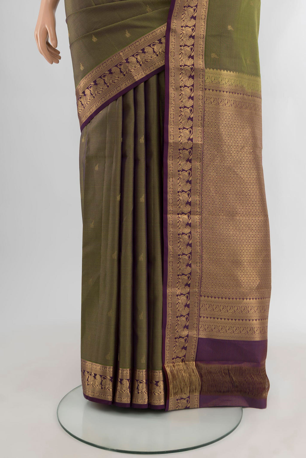 Pleats and pallu of Mehandi Green Kanjivaram Silk Saree with Zari Butta on the body and Zari Border. 