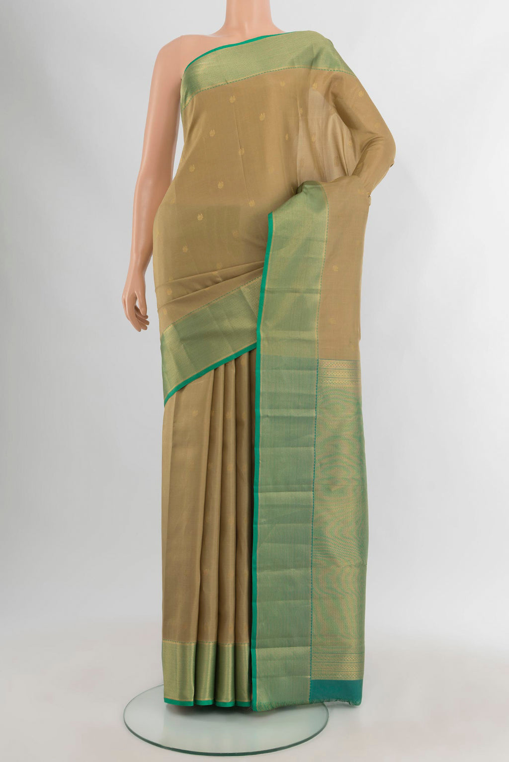 Beige Kanjivaram Silk Saree with Zari Butta on the body and Zari Border.  displayed on a mannequin