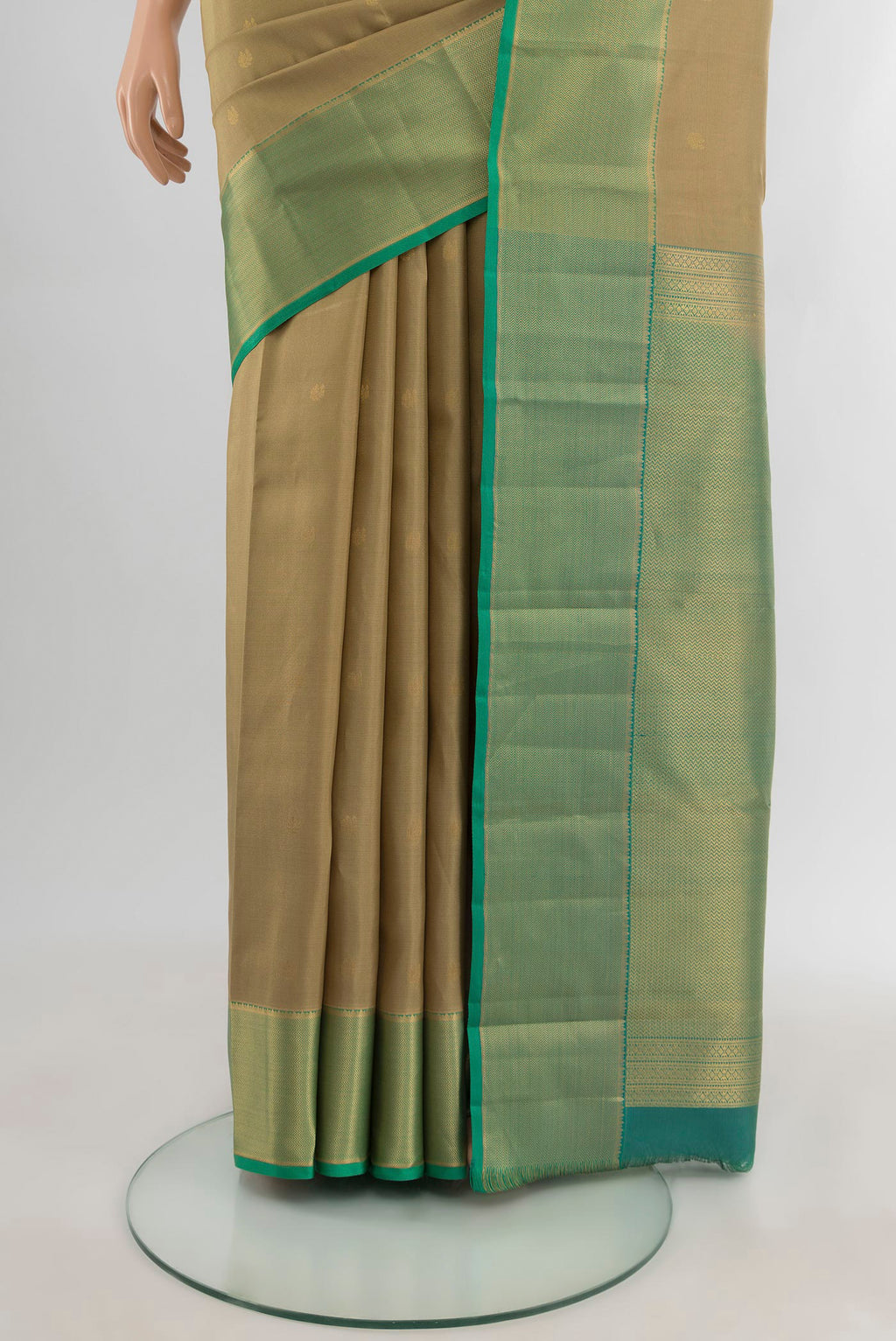 Pleats and pallu of Beige Kanjivaram Silk Saree with Zari Butta on the body and Zari Border. 