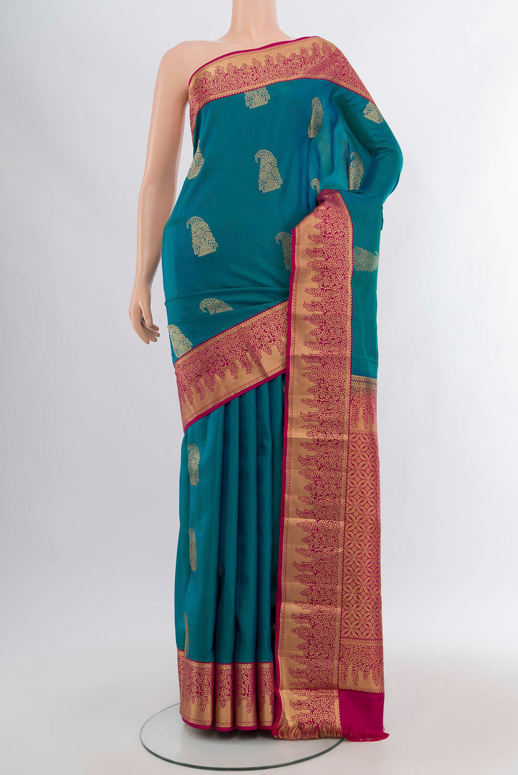Peacock Blue Kanjivaram Silk Saree with Zari Butta on the body and Zari Border.  displayed on a mannequin