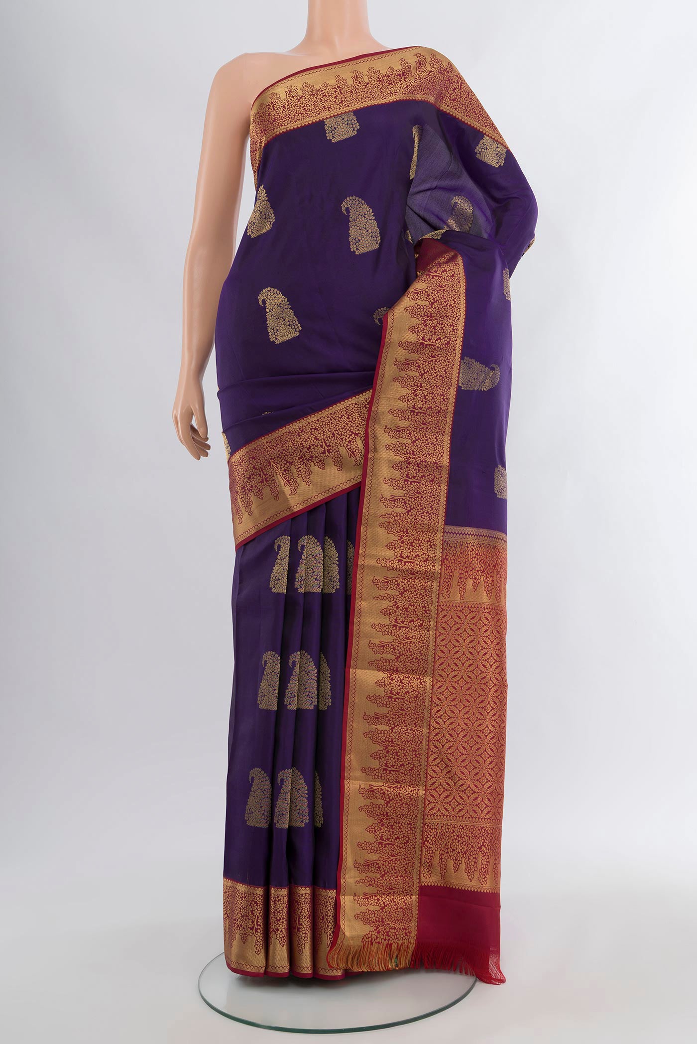Violet Kanjivaram Silk Saree with Zari Butta on the body and Zari Border.  displayed on a mannequin