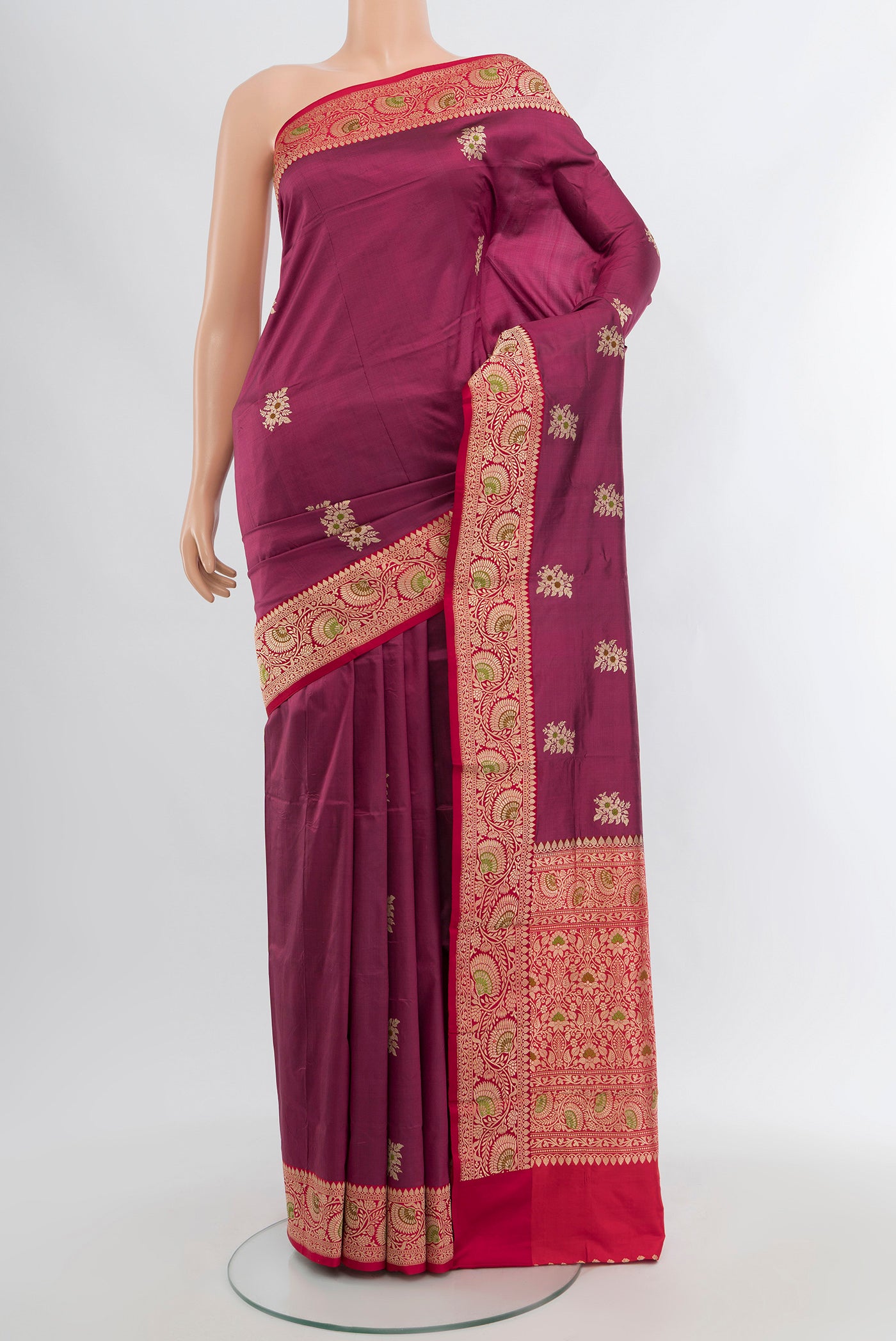 Maroon Banarasi Katan Silk Saree with Zari Butta on the body and Zari Border.  displayed on a mannequin