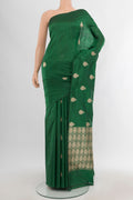 Bottle Green Banarasi Katan Silk Saree with Zari Butta on the body and Without Border.  displayed on a mannequin