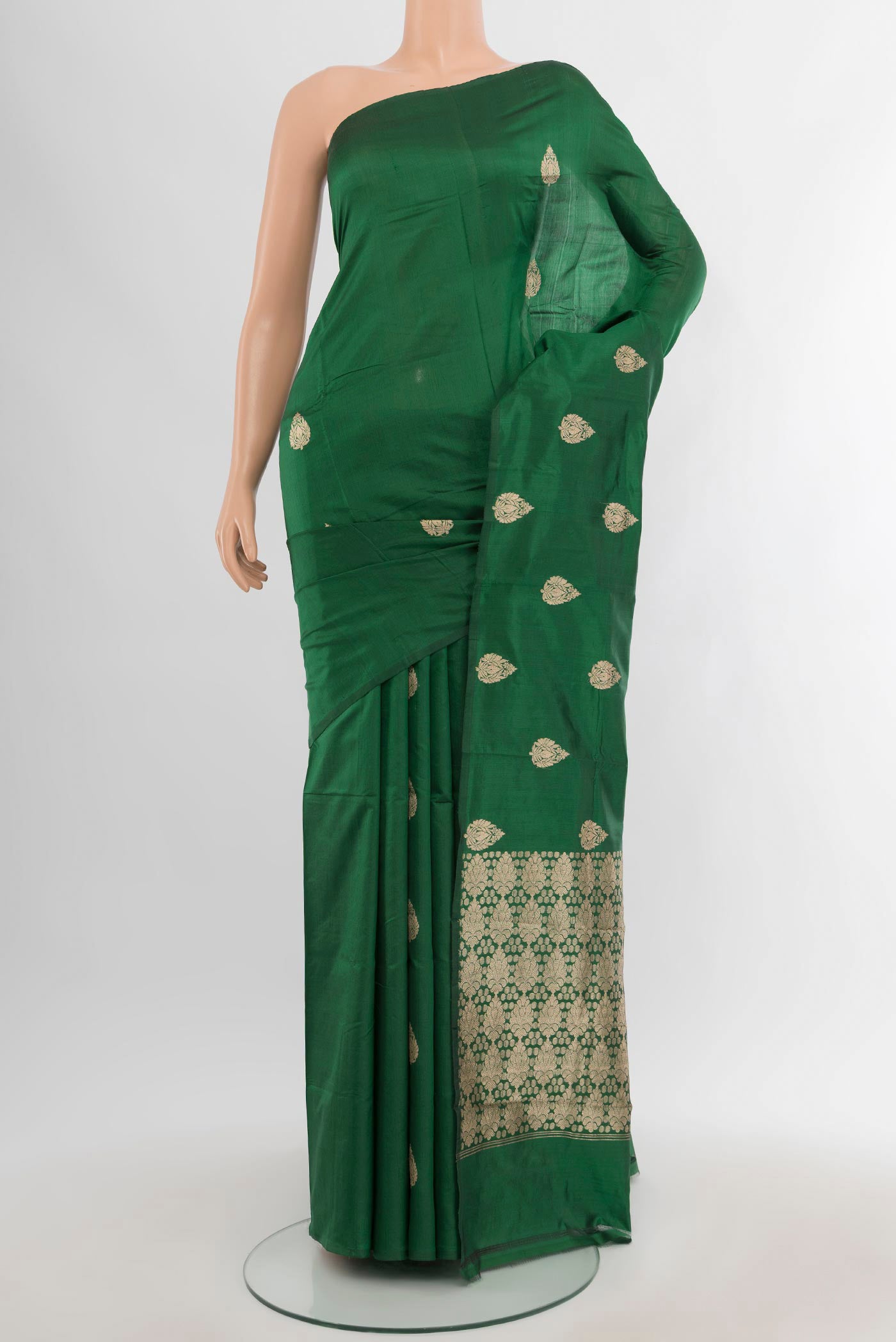 Bottle Green Banarasi Katan Silk Saree with Zari Butta on the body and Without Border.  displayed on a mannequin