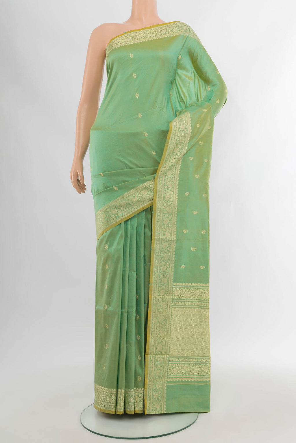 Light Green Banarasi Katan Silk Saree with Zari Butta on the body and Zari Border.  displayed on a mannequin