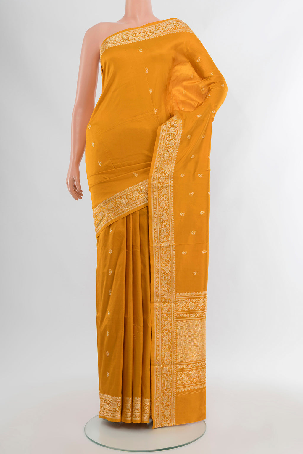 Yellow Banarasi Katan Silk Saree with Zari Butta on the body and Silk Border.  displayed on a mannequin