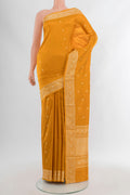 Yellow Banarasi Katan Silk Saree with Zari Butta on the body and Silk Border.  displayed on a mannequin