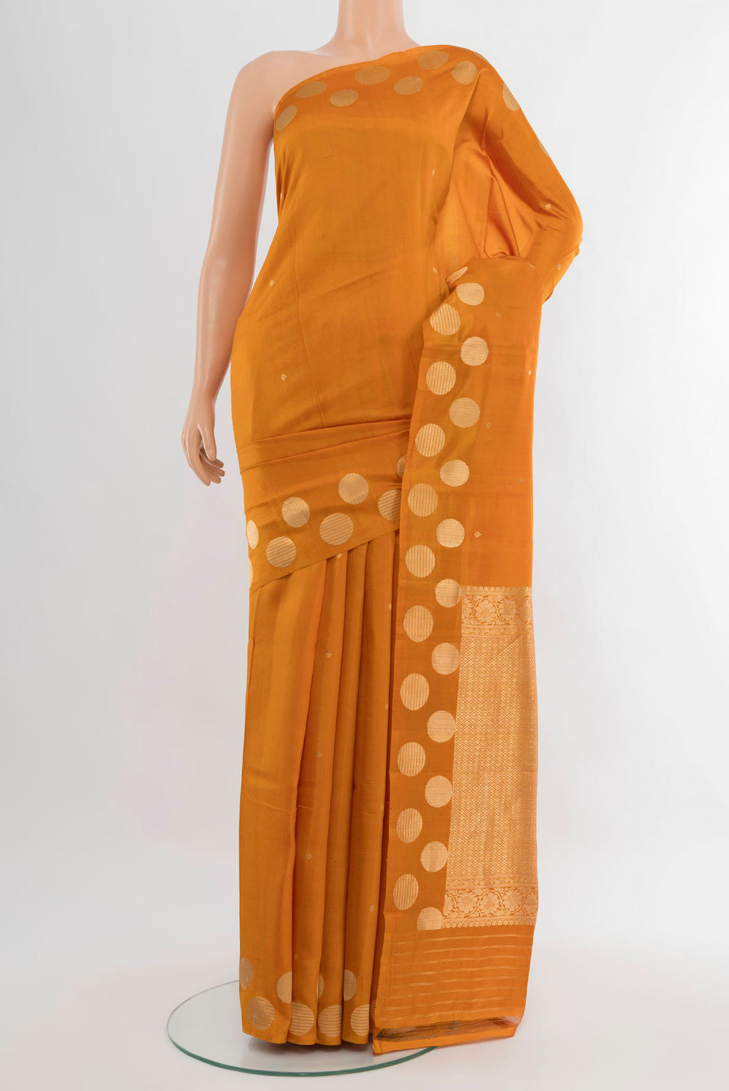 Mustard Banarasi Katan Silk Saree with Zari Butta on the body and Without Border.  displayed on a mannequin