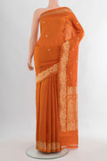 Pure Silk Brick Orange Banarasi Katan Saree with Zari Butta on the body and Zari Border.  displayed on a mannequin