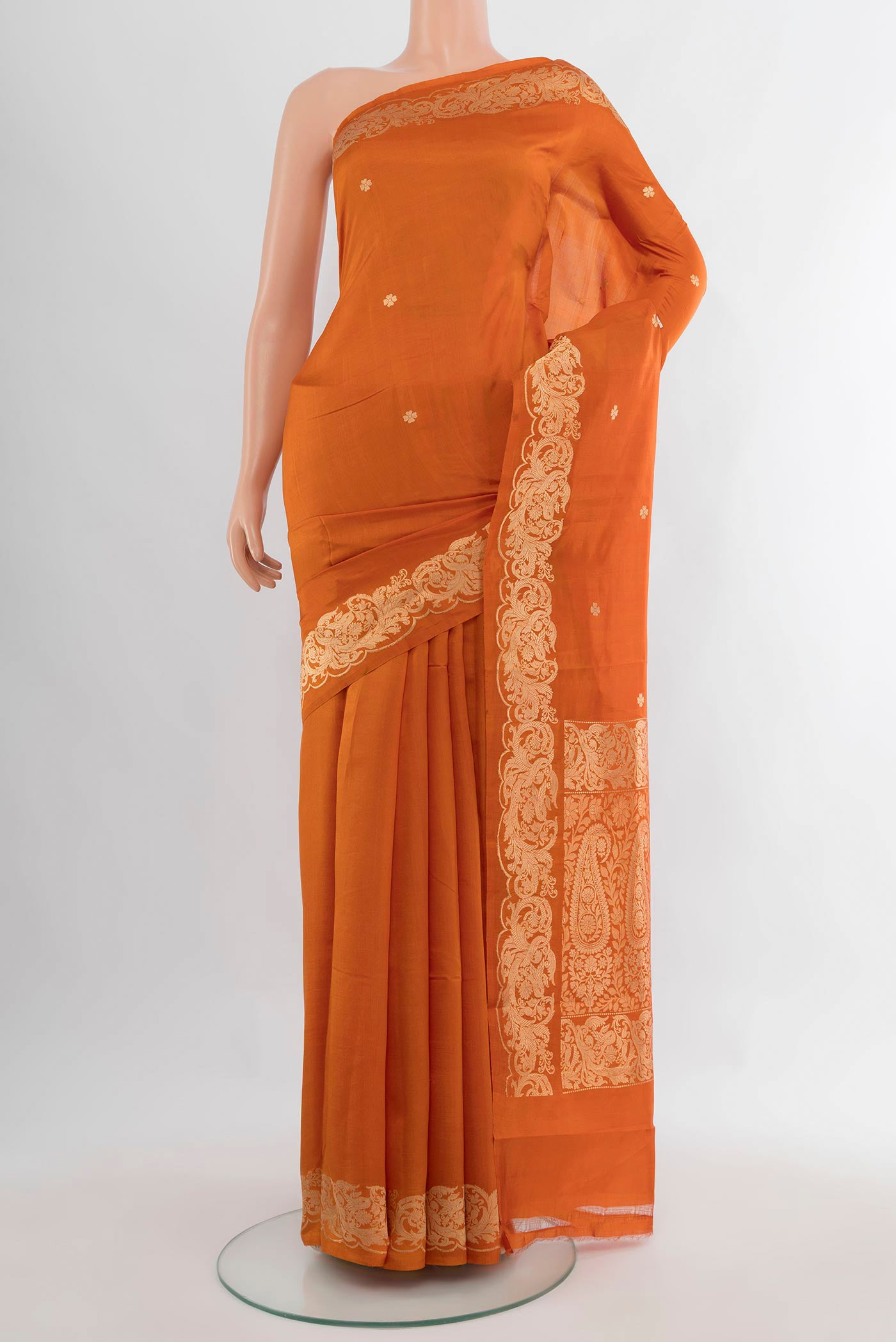 Pure Silk Brick Orange Banarasi Katan Saree with Zari Butta on the body and Zari Border.  displayed on a mannequin