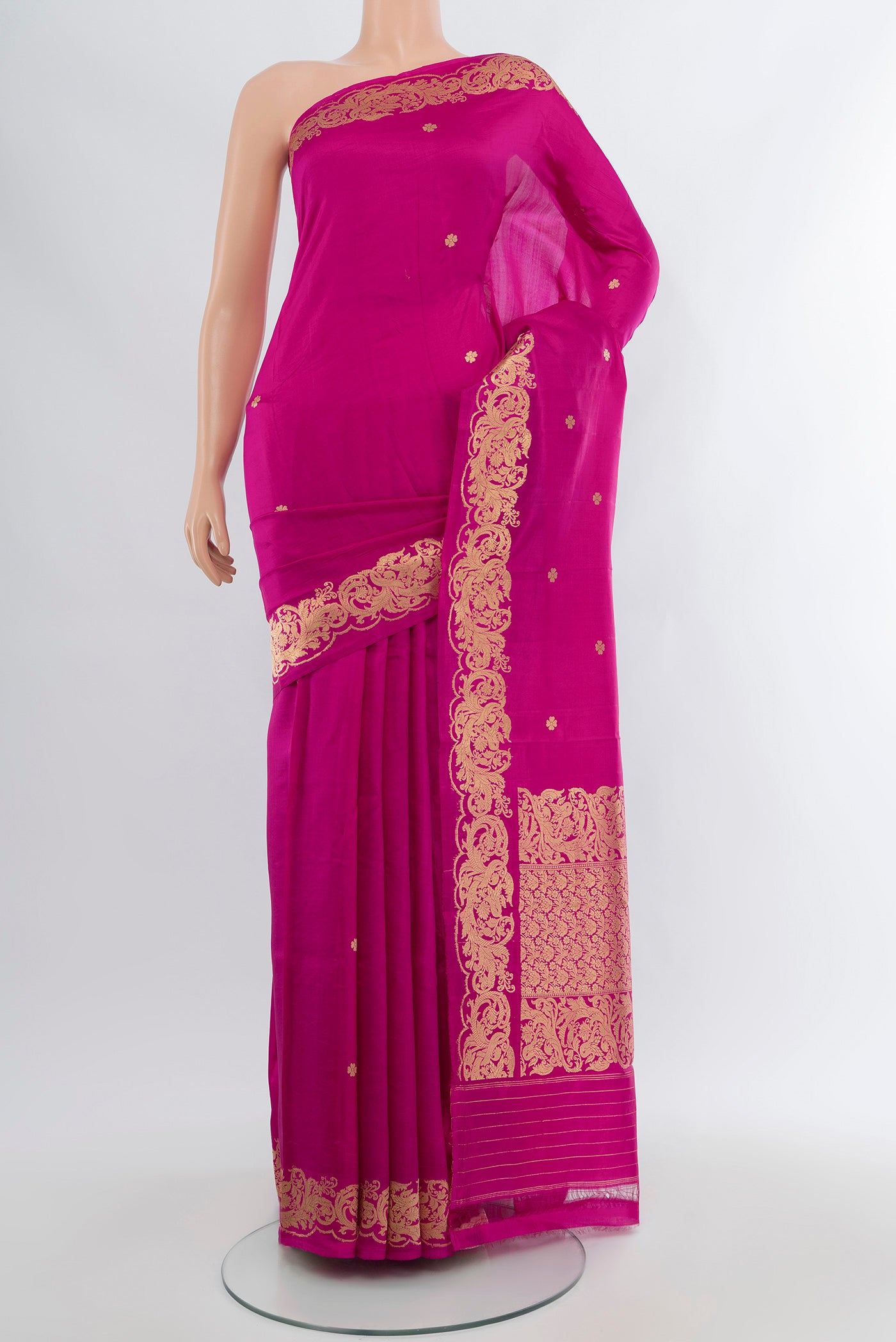 Magenta Banarasi Katan Silk Saree with Zari Butta on the body and Zari Border.  displayed on a mannequin