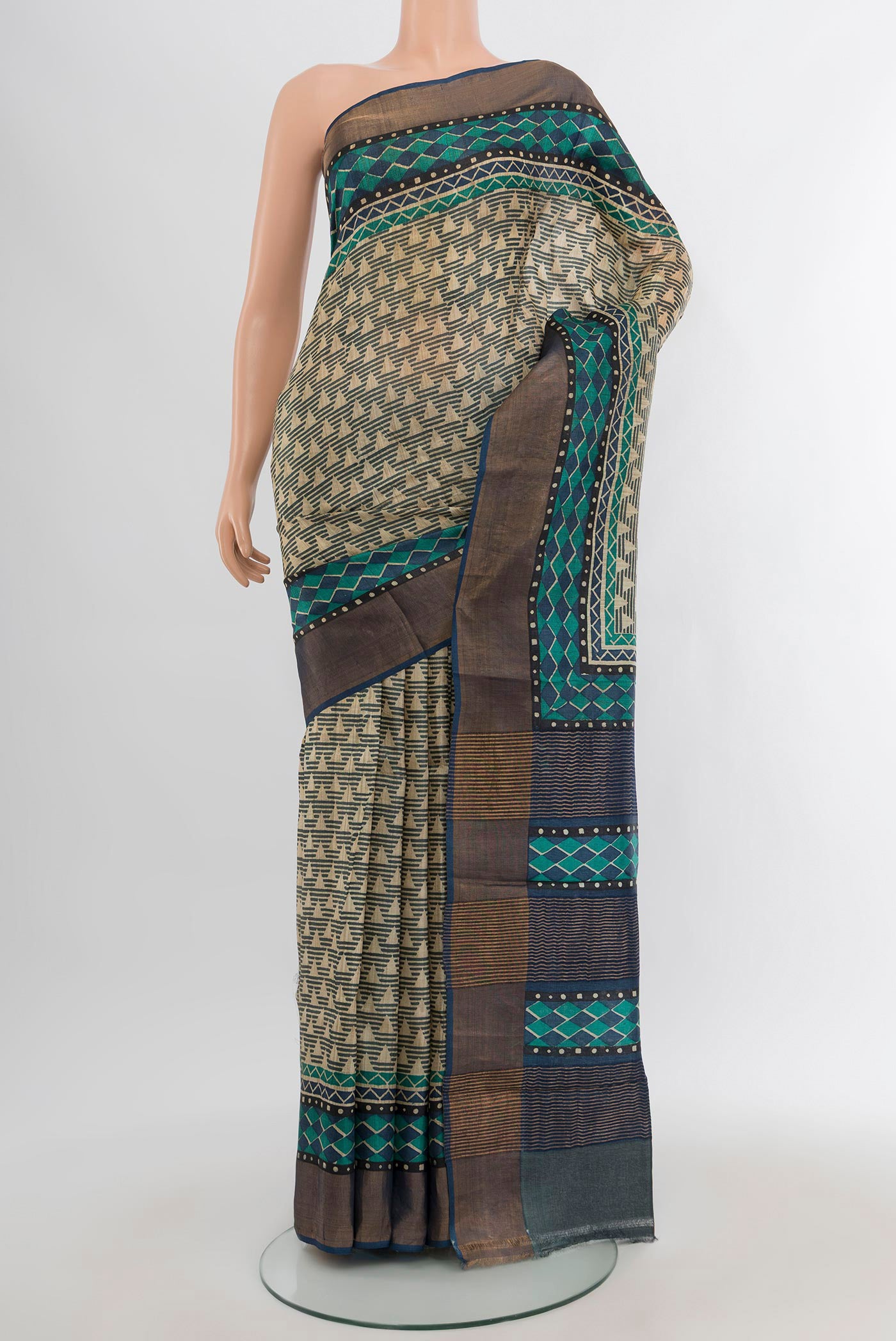 Beige Tussar Silk Saree with Geometric Print on the body and Zari Border.  displayed on a mannequin