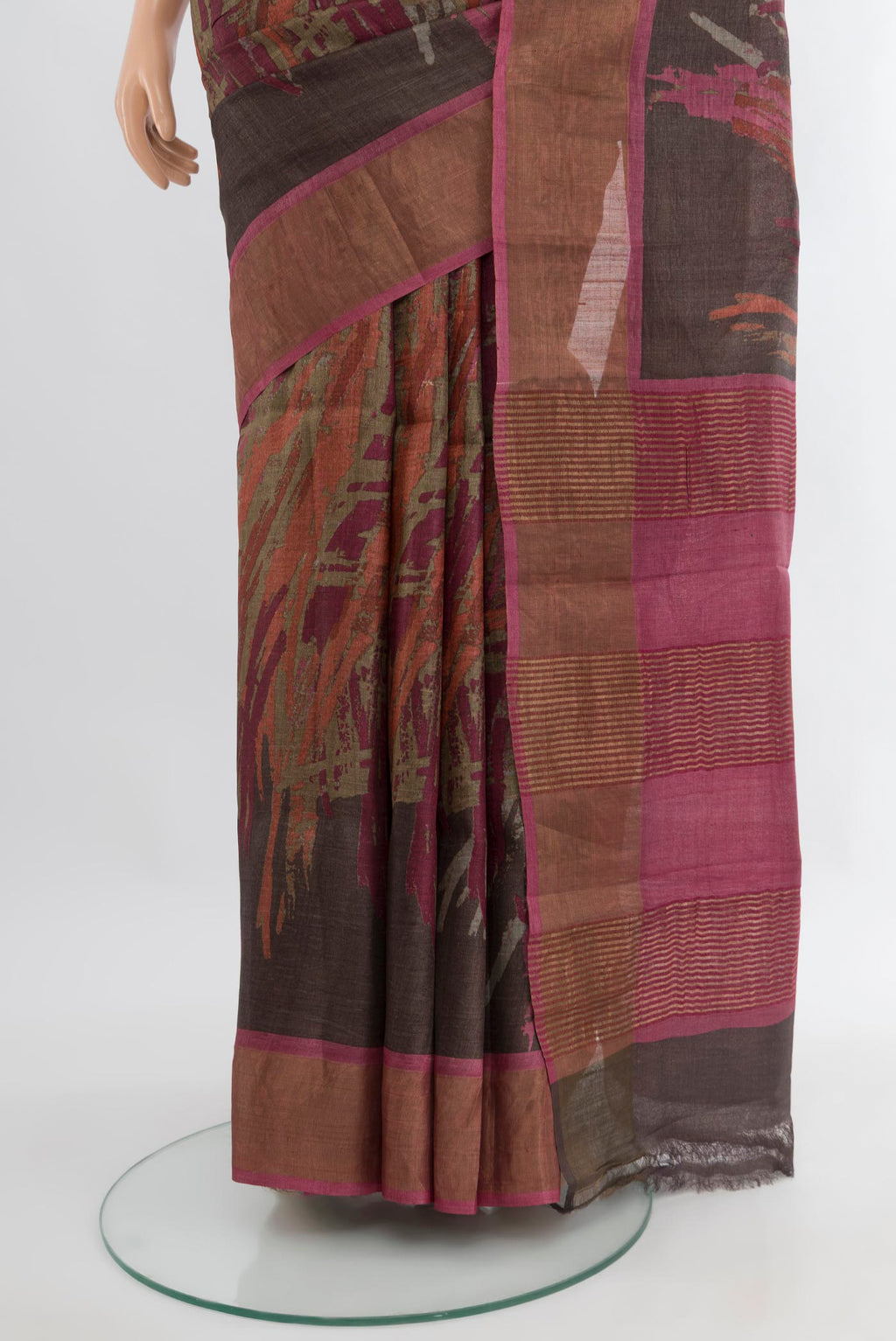 Pleats and pallu of Brown Tussar Silk Saree with Floral Print on the body and Zari Border. 