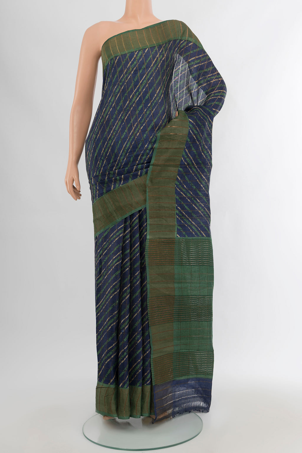 Navy Blue Tussar Silk Saree with Floral Print on the body and Zari Border.  displayed on a mannequin