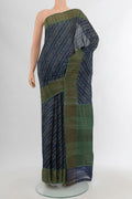 Navy Blue Tussar Silk Saree with Floral Print on the body and Zari Border.  displayed on a mannequin