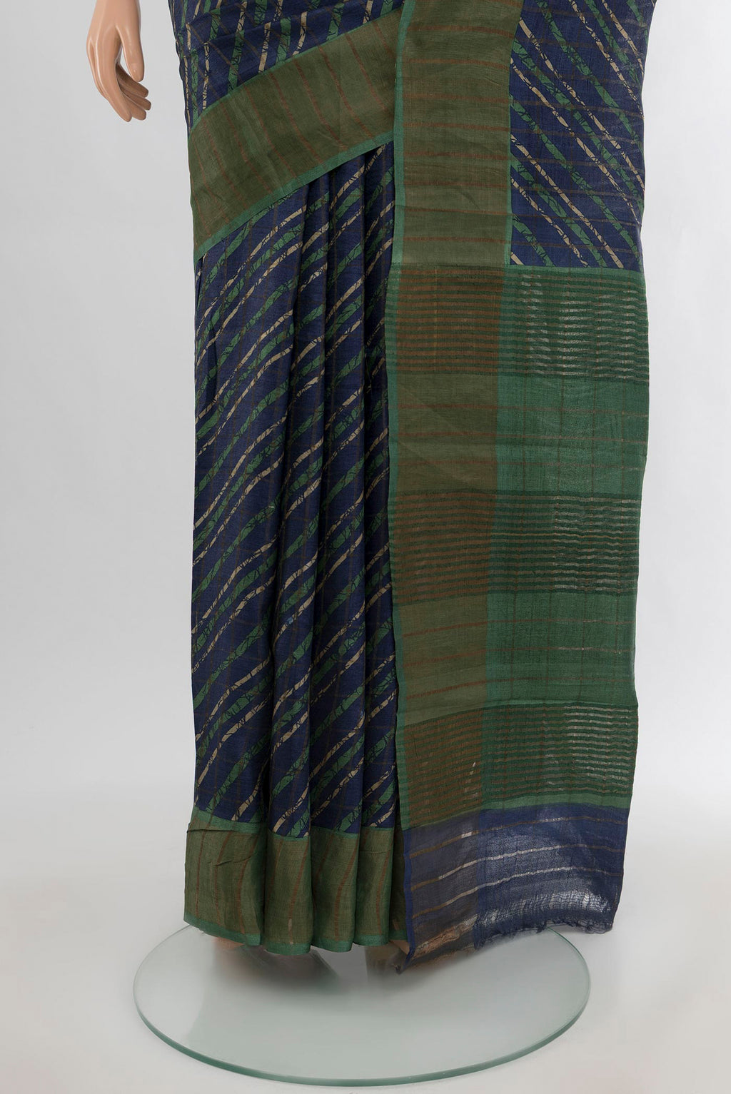 Pleats and pallu of Navy Blue Tussar Silk Saree with Floral Print on the body and Zari Border. 