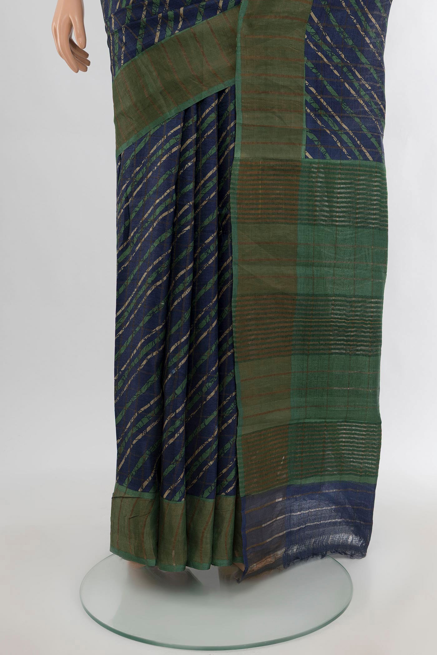 Pleats and pallu of Navy Blue Tussar Silk Saree with Floral Print on the body and Zari Border. 