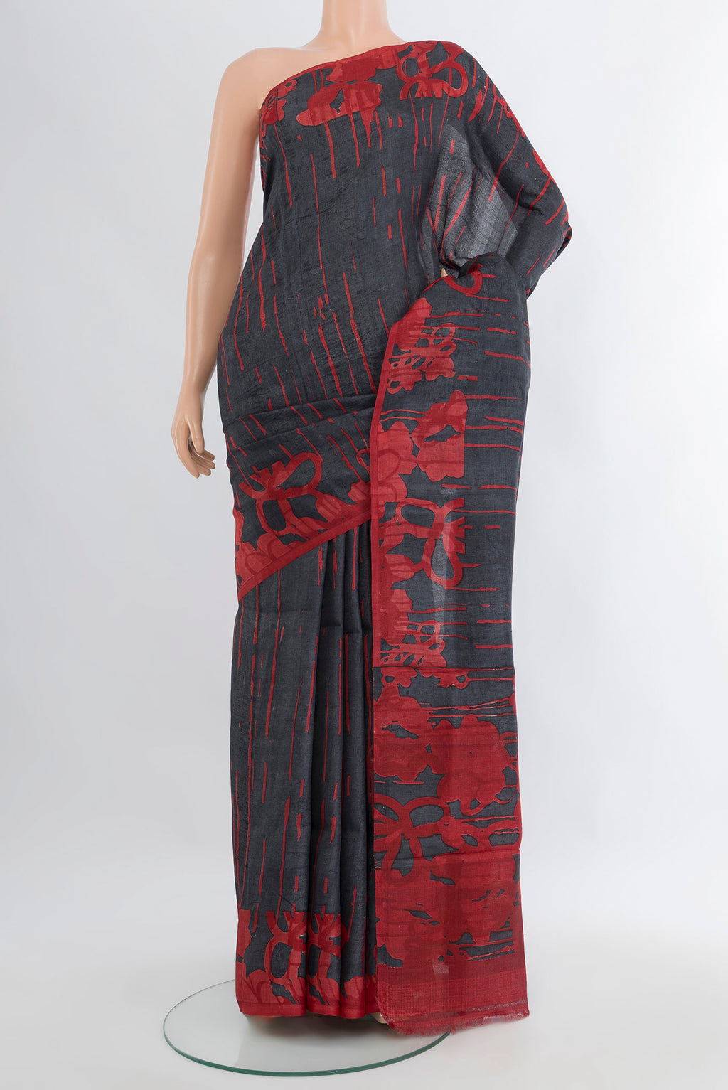 Black Tussar Silk Saree with Floral Print on the body and Without Border.  displayed on a mannequin