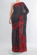 Black Tussar Silk Saree with Floral Print on the body and Without Border.  displayed on a mannequin
