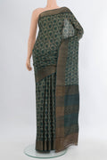 Bottle Green Tussar Silk Saree with Floral Print on the body and Zari Border.  displayed on a mannequin