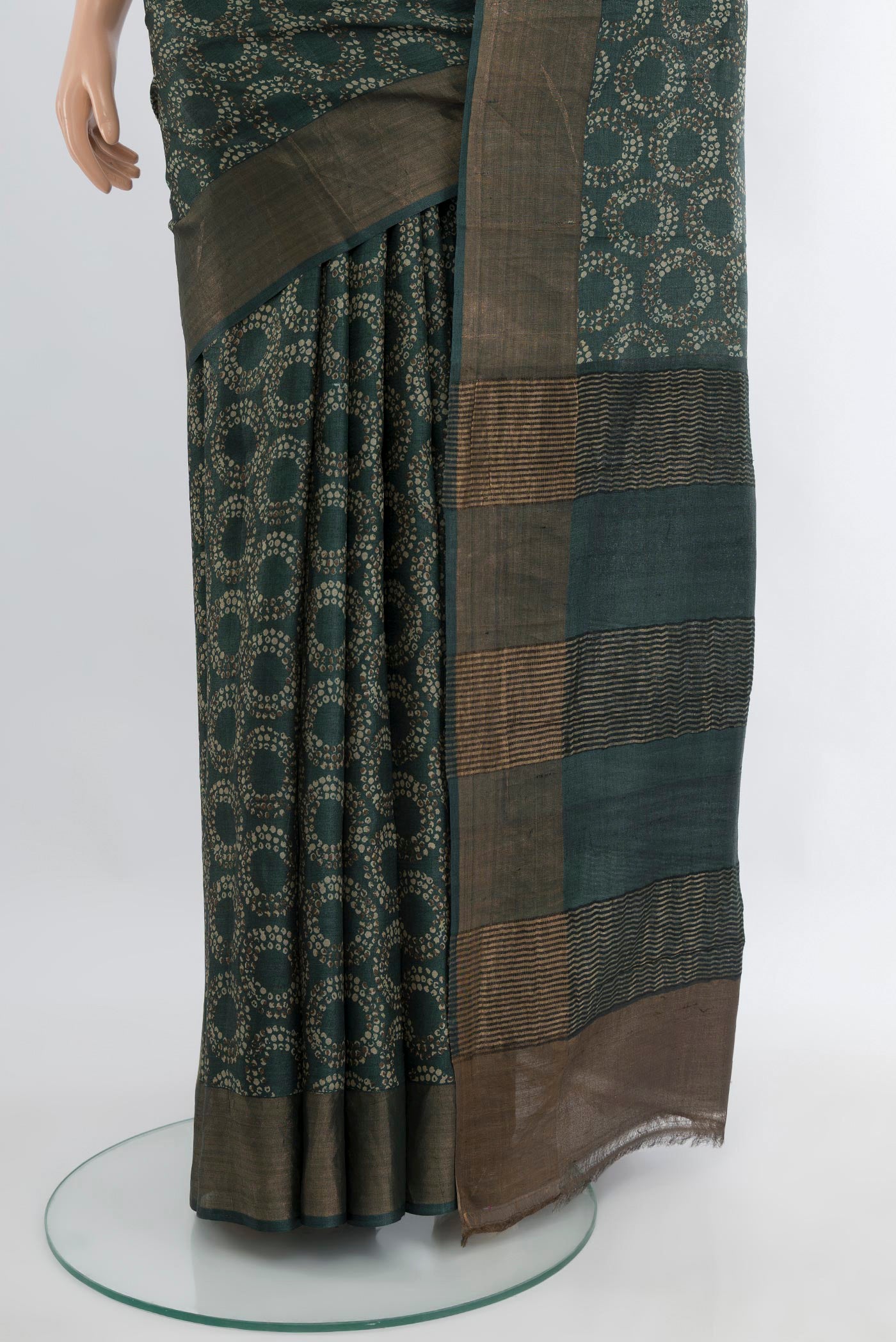 Pleats and pallu of Bottle Green Tussar Silk Saree with Floral Print on the body and Zari Border. 