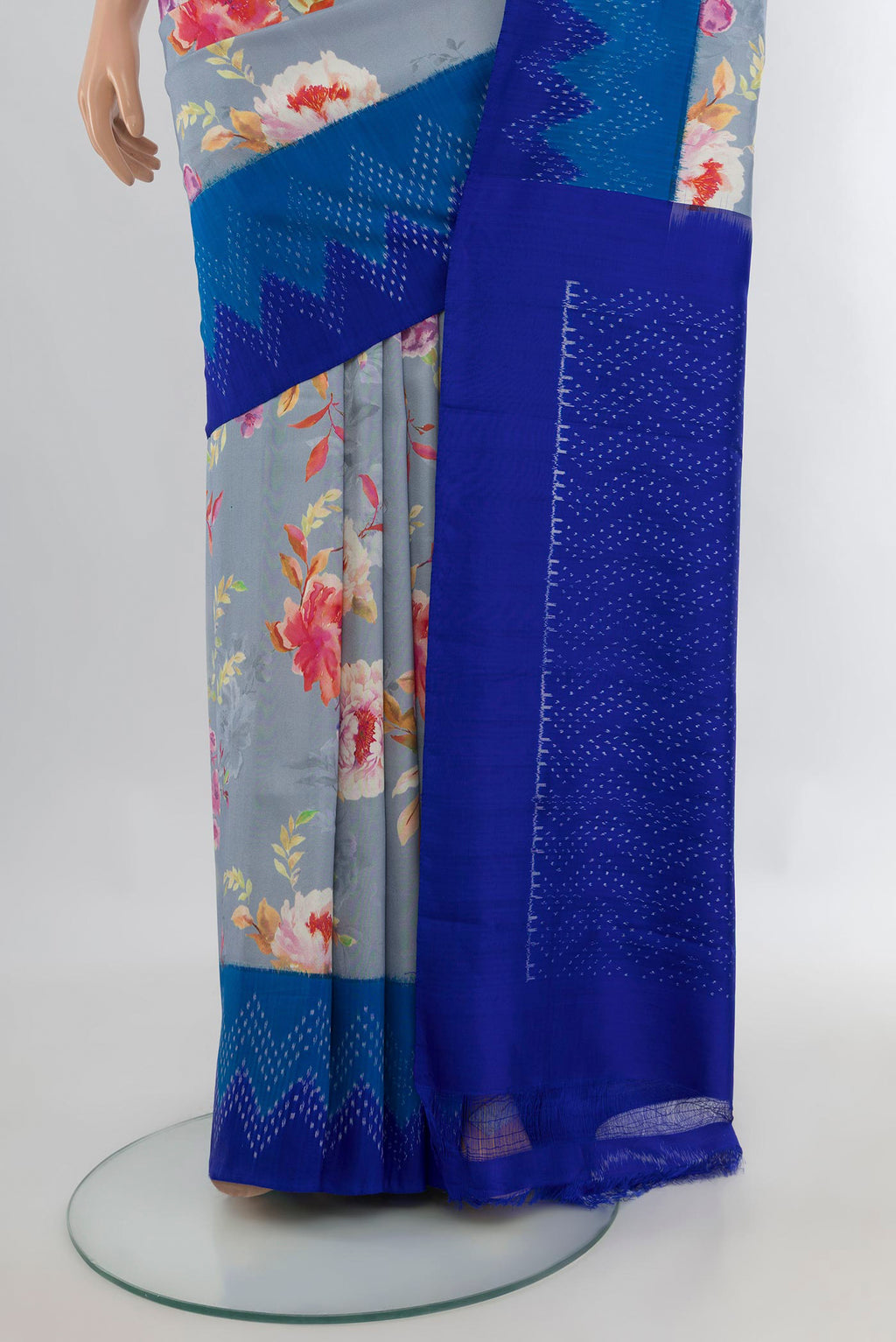 Pleats and pallu of Pure Silk Light Blue Printed Saree with Floral Print on the body and Ikat Border. 