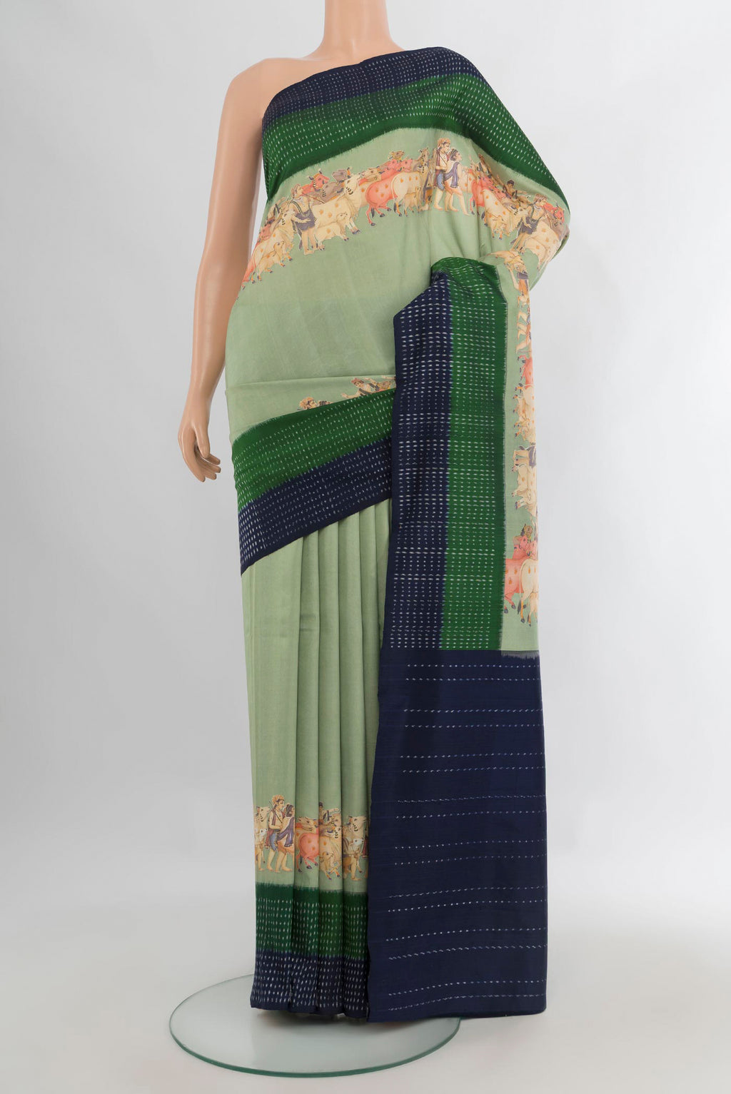 Pure Silk Light Green Printed Saree with Plain Body and Ikat Border.  displayed on a mannequin